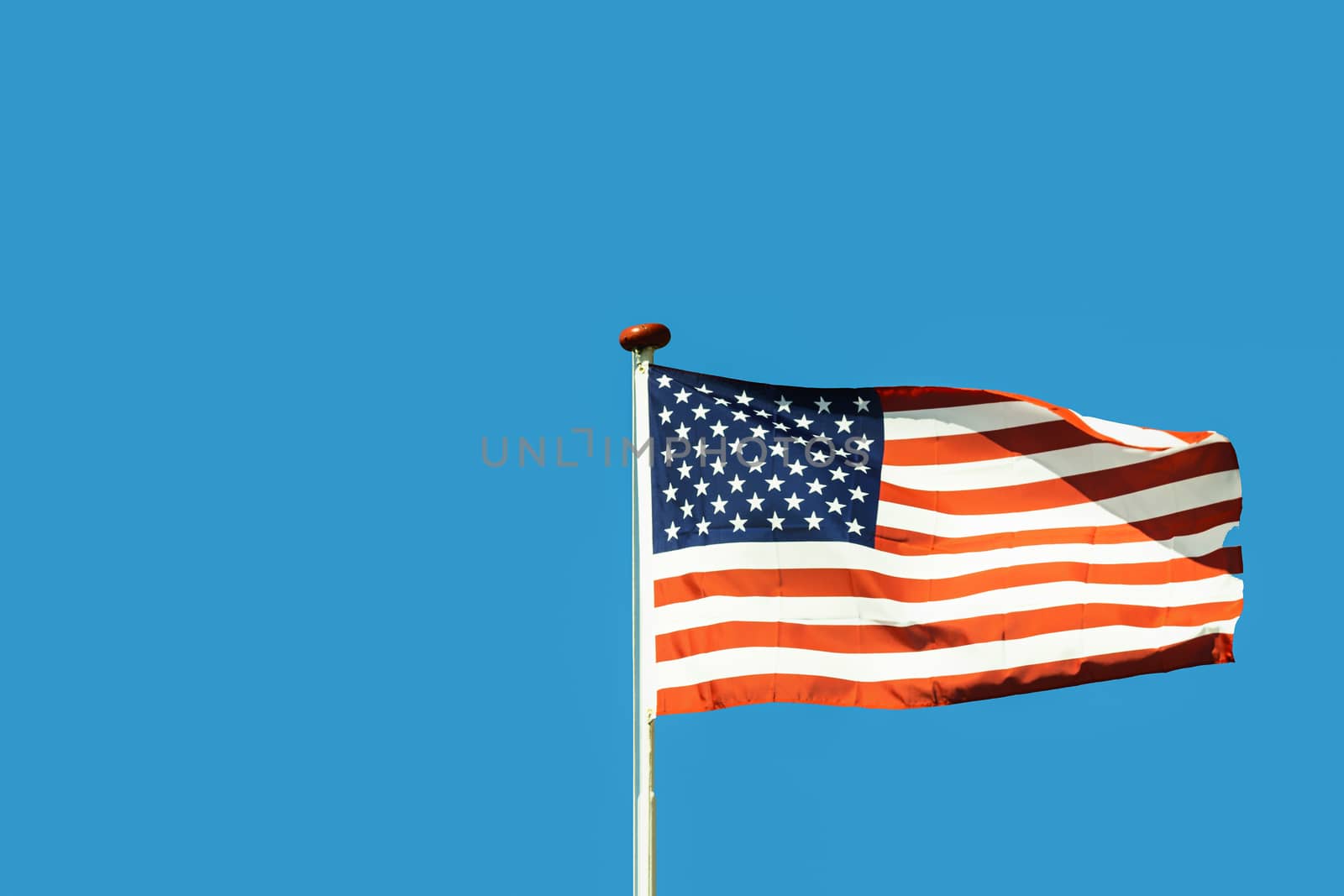 Billowing usa flag against blue sky horizontal