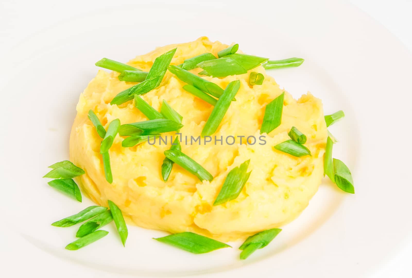 Mushed potato on a white plate isolated on white background