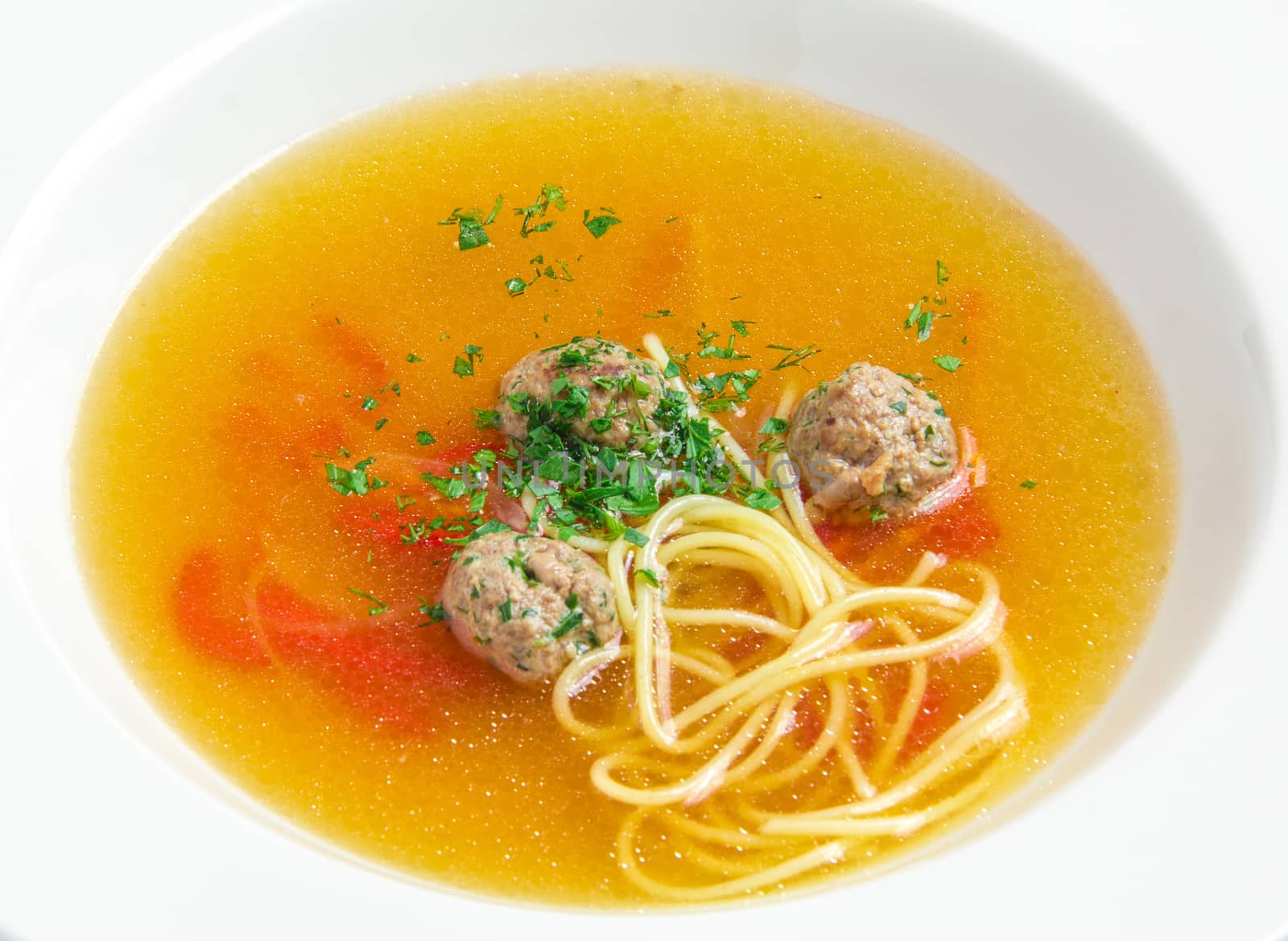 Vegetable soup with meatballs  on white plate