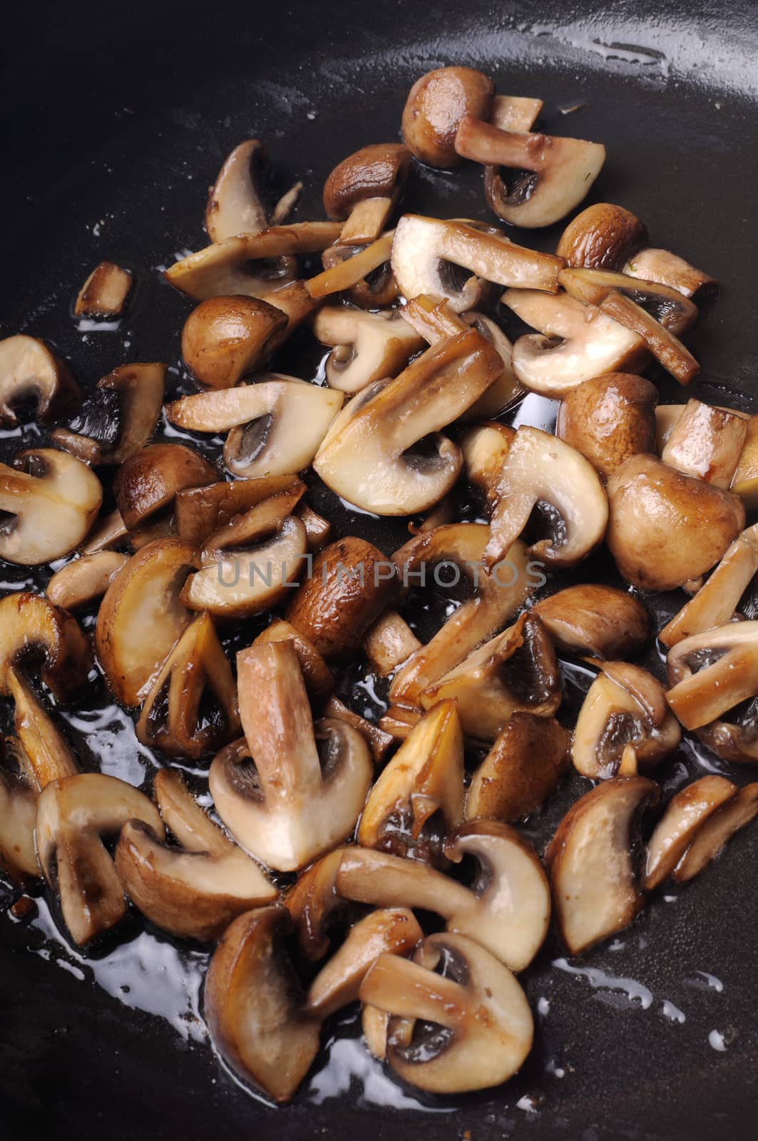 Fried sliced mushrooms in butter in a frying pan. For step by step recipe