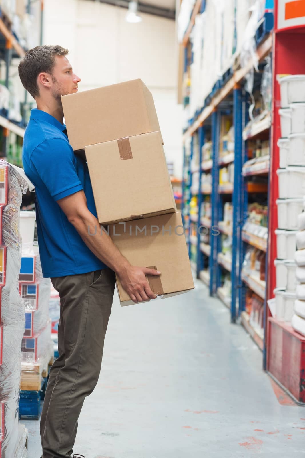 Worker carrying boxes in warehouse by Wavebreakmedia