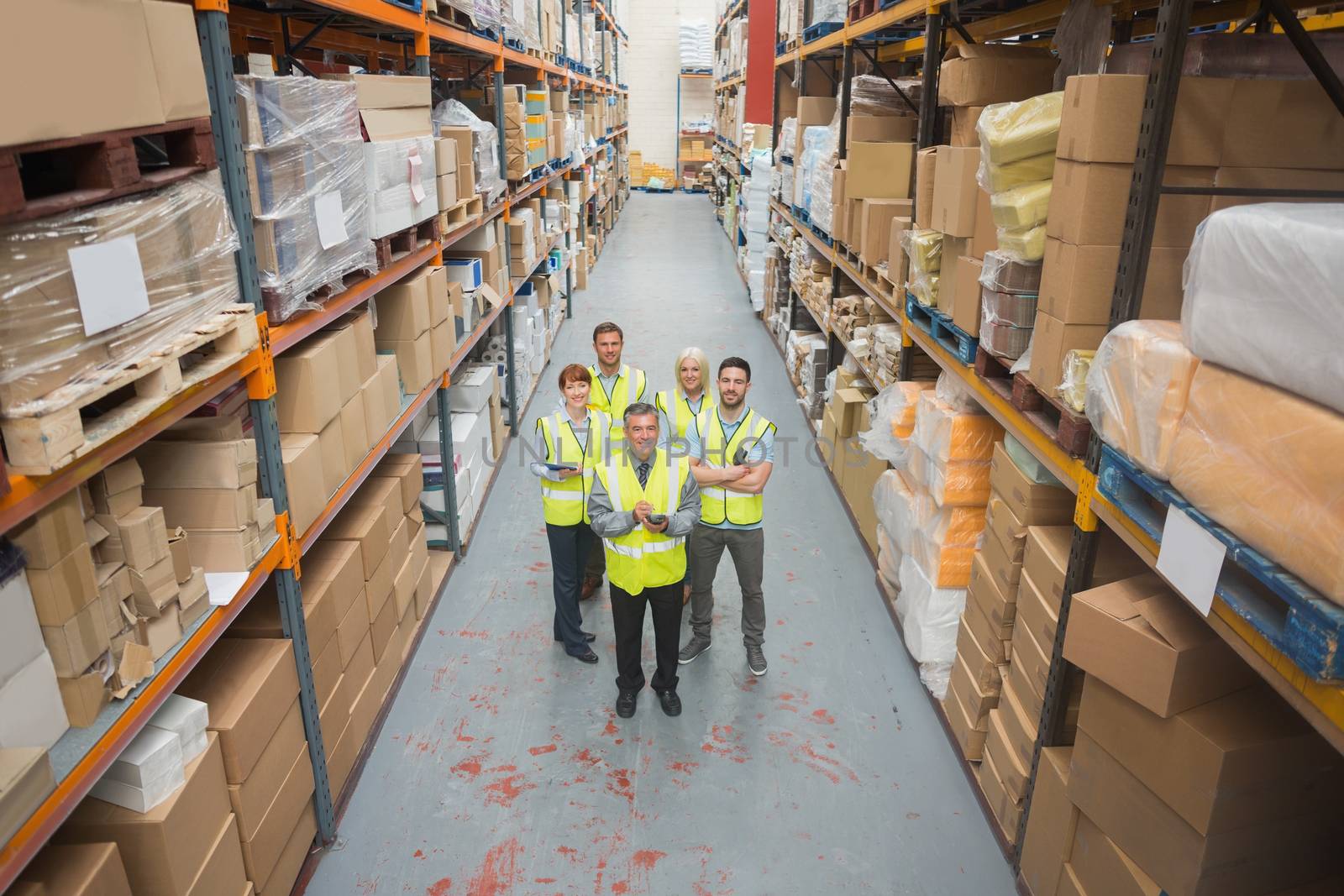 Warehouse team smiling at camera by Wavebreakmedia