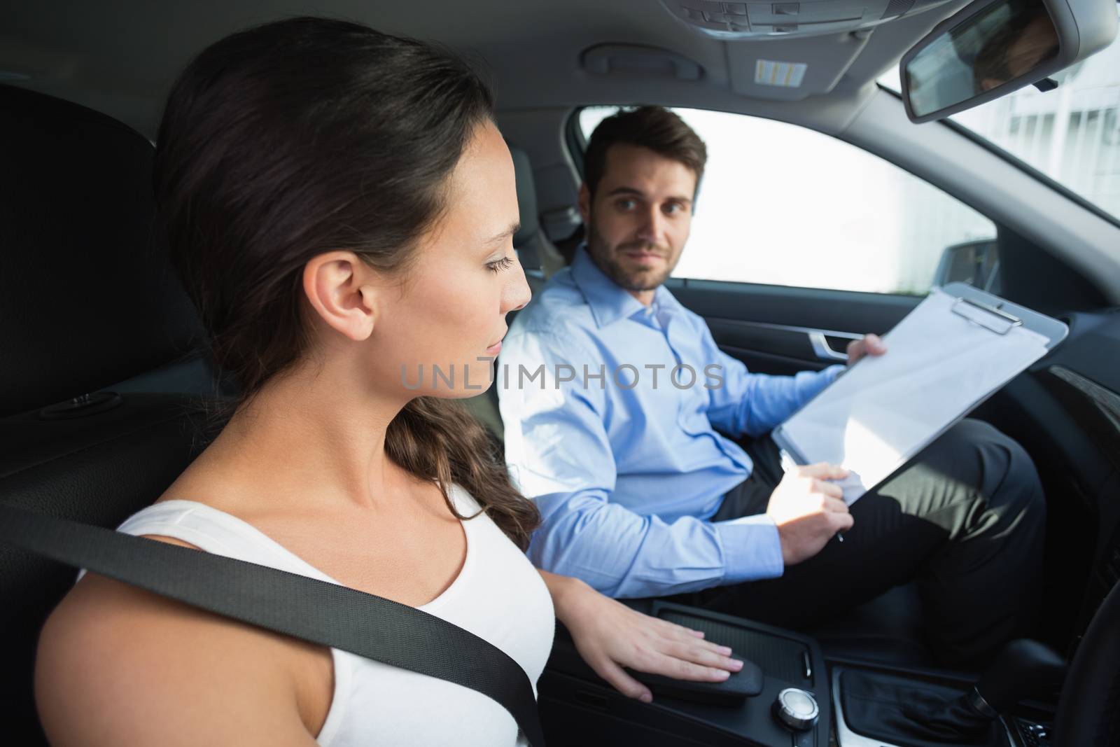 Young woman getting a driving lesson by Wavebreakmedia