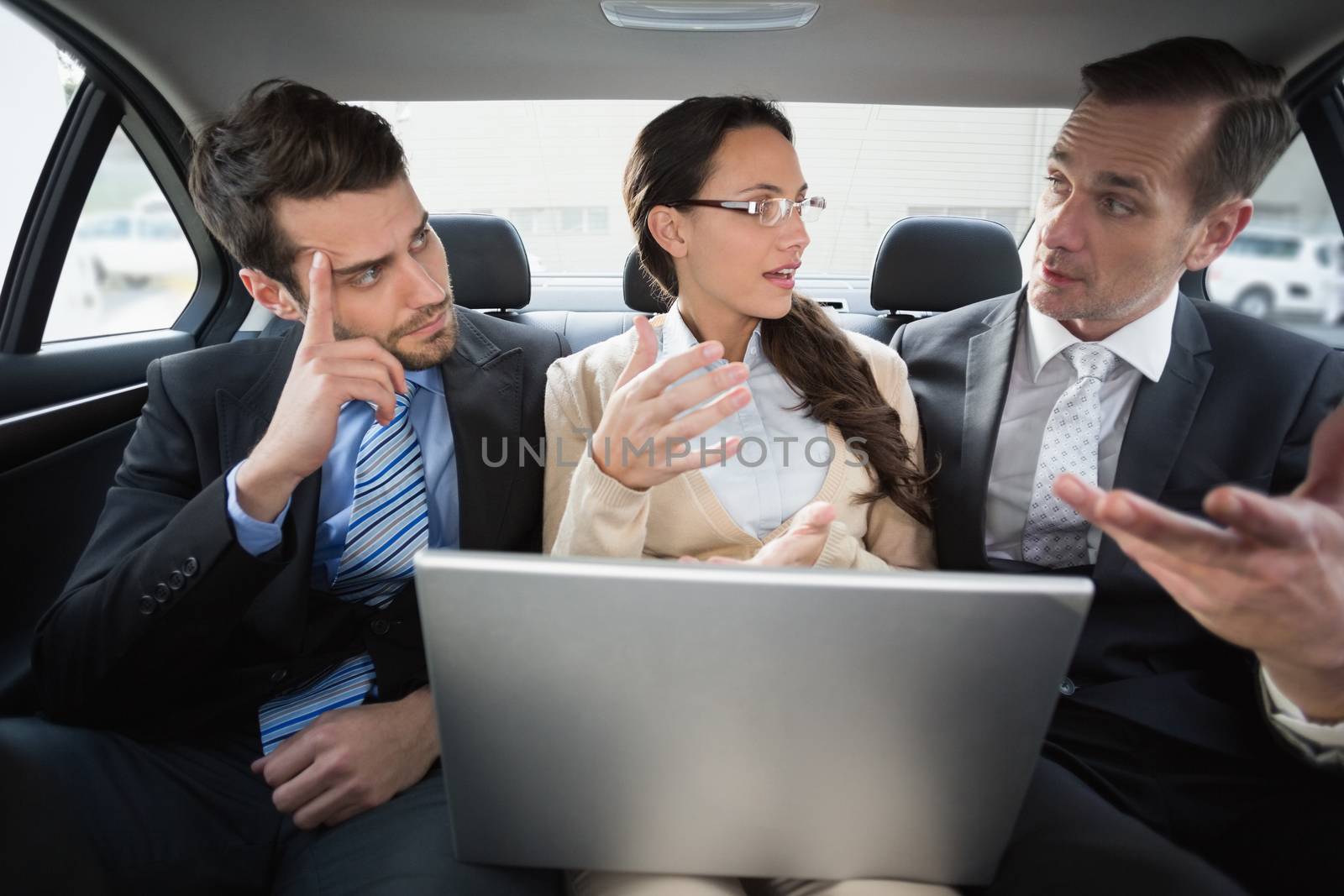 Business team working in the back seat in the car