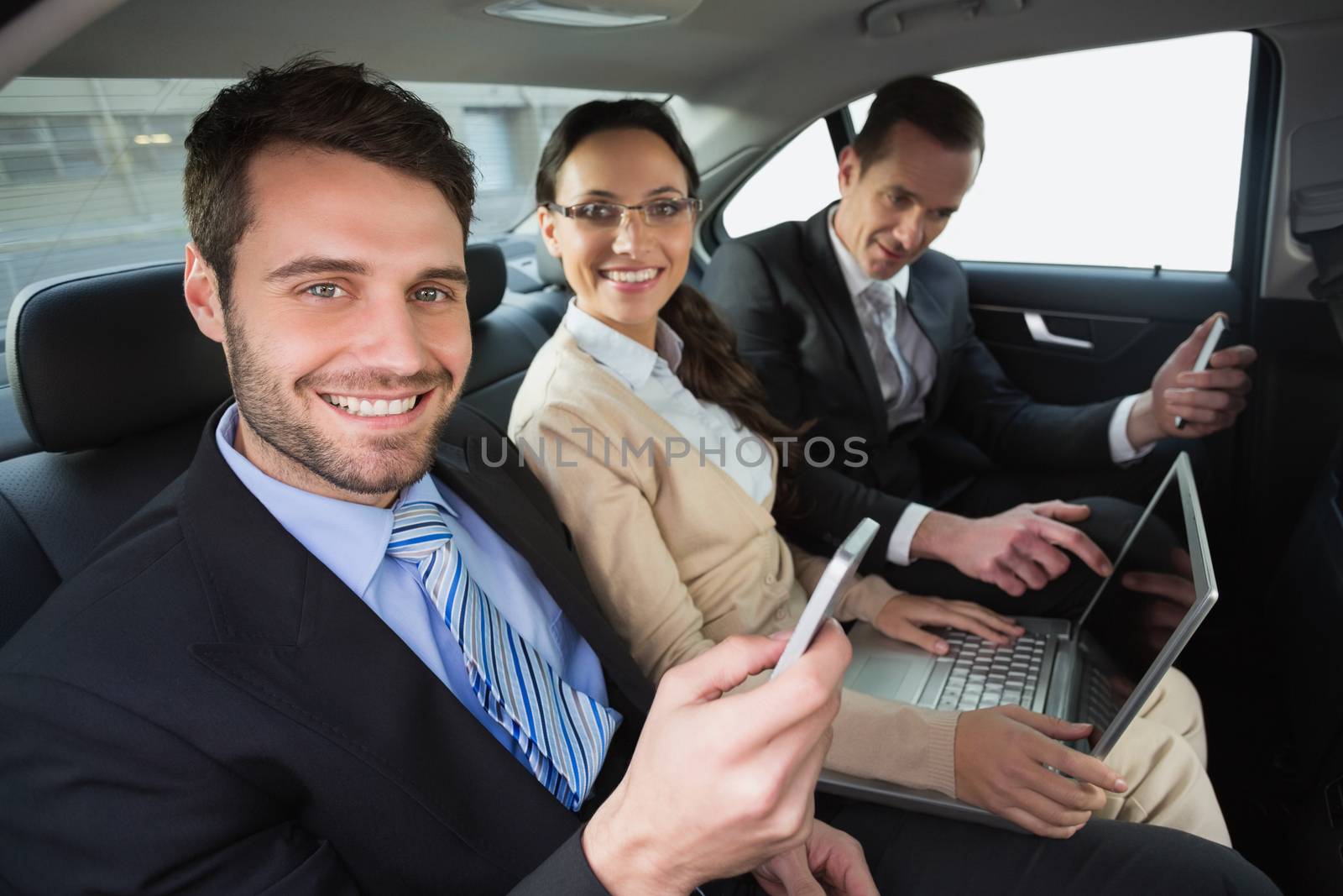 Business team working in the back seat in the car