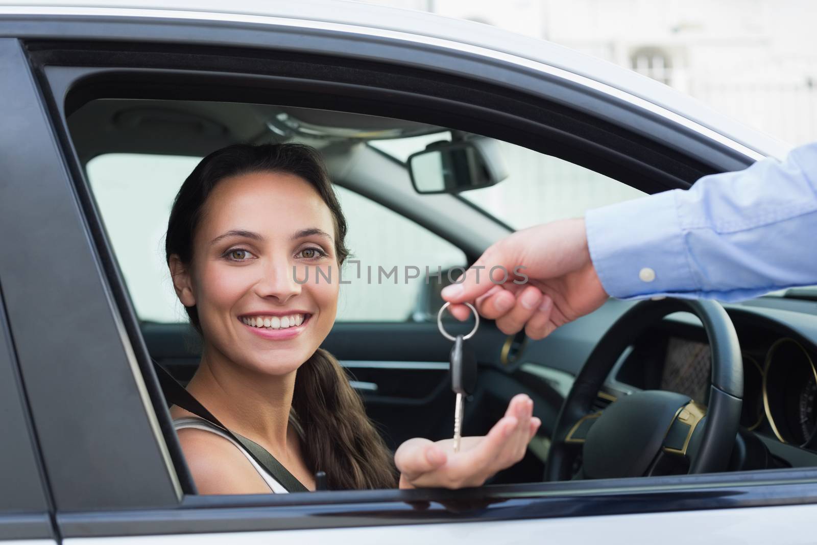 Young woman getting her key in the car