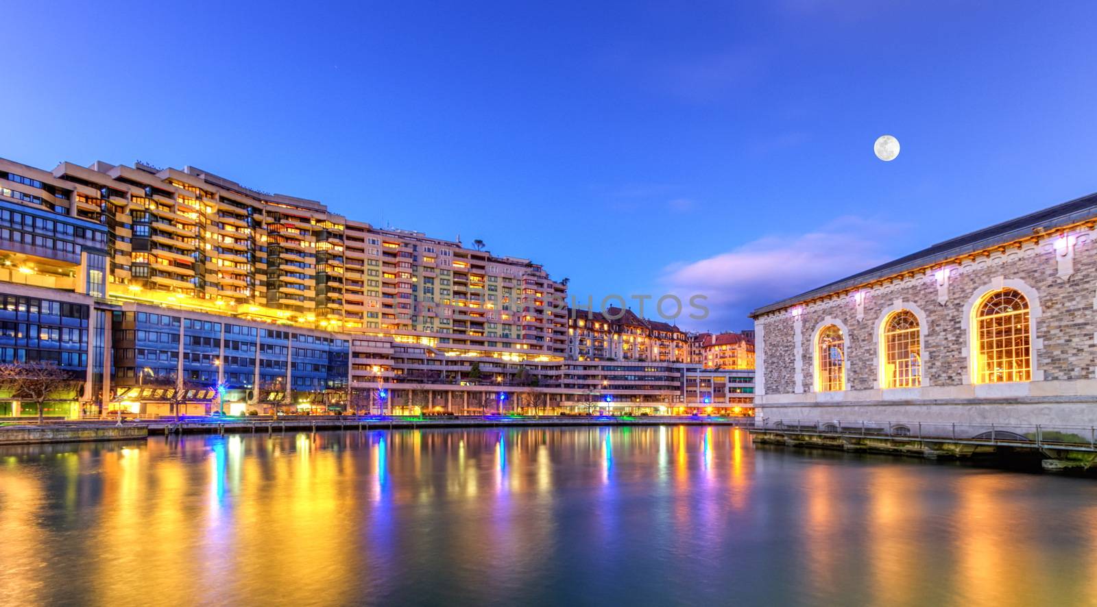 BFM buildings and Rhone river by night with full moon, Geneva, Switzerland, HDR