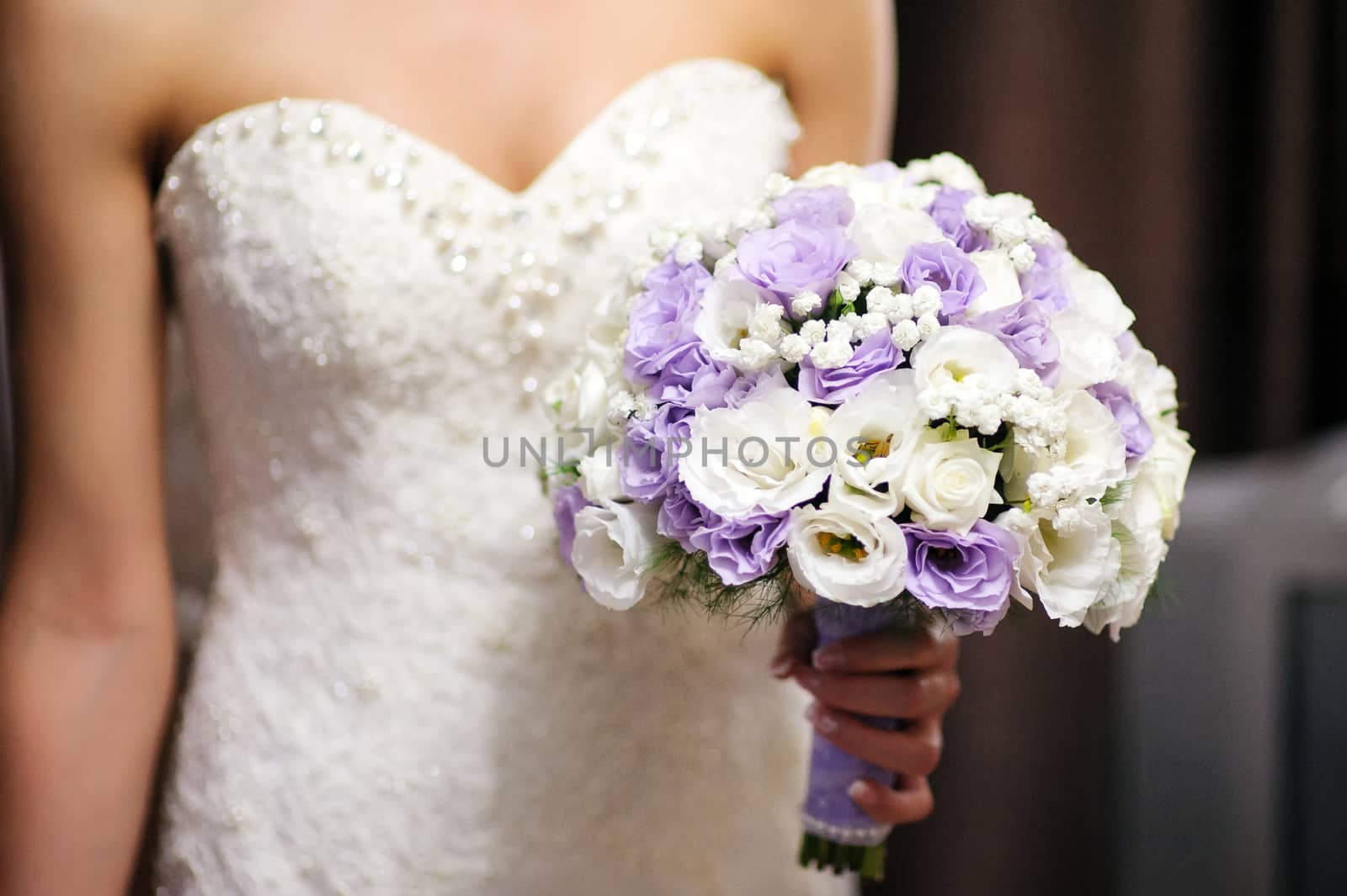 Bride holding a bouquet of roses