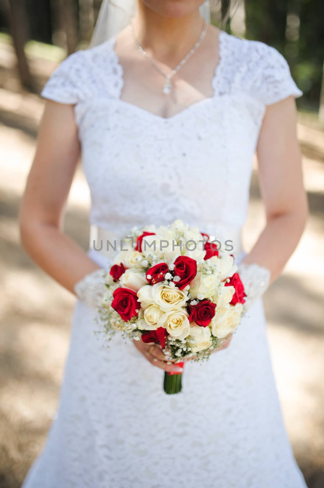 Bride holding a bouquet of roses