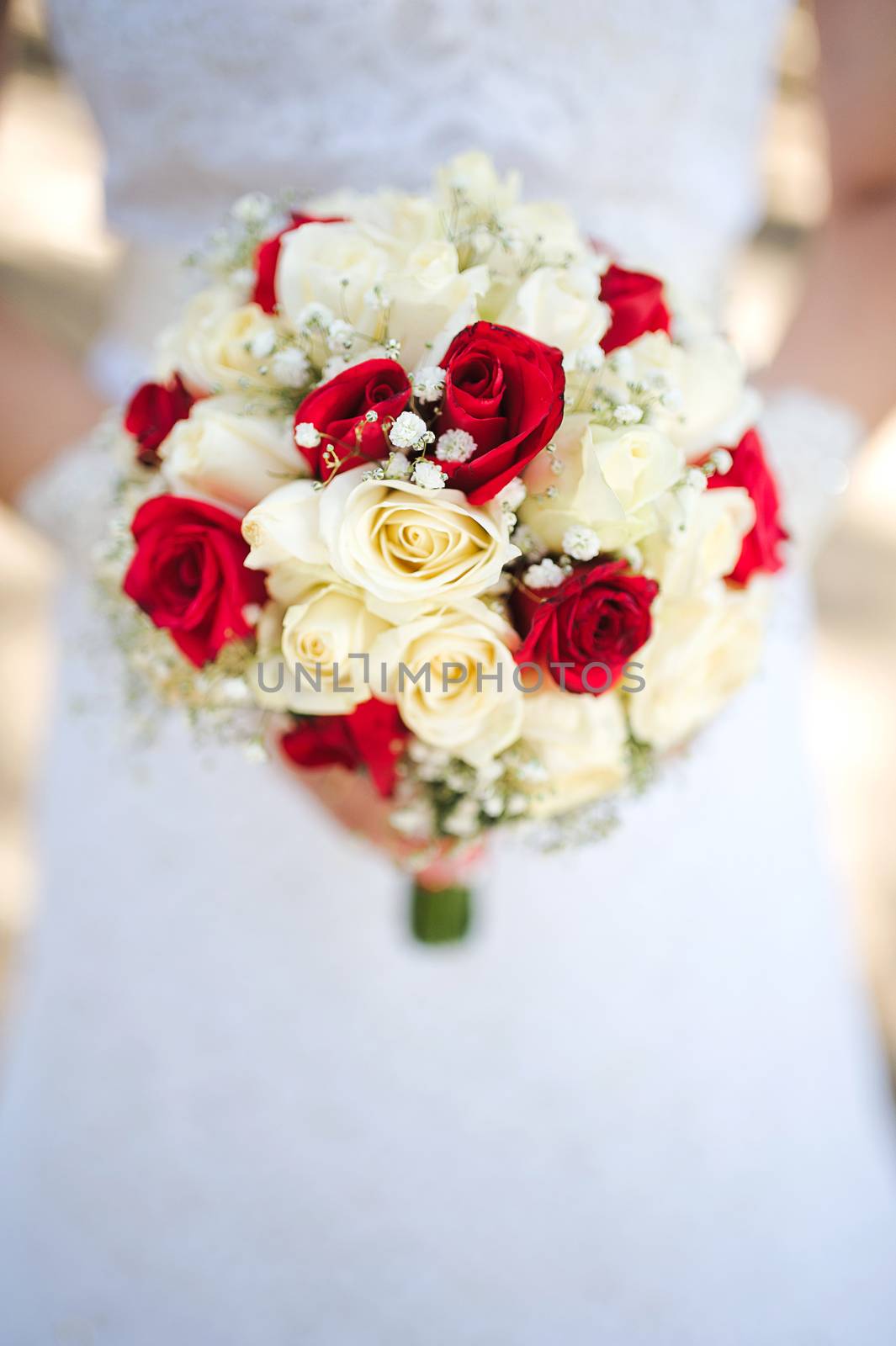 Bride holding a bouquet of roses by eugenelucky