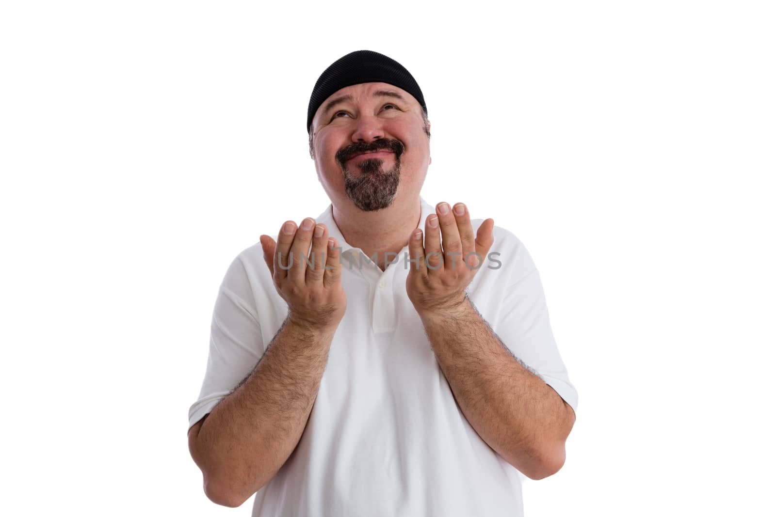 Middle-aged casual man with a goatee imploring God to find a solution raising his hands in supplication and looking up to heaven with a beseeching expression, isolated on white