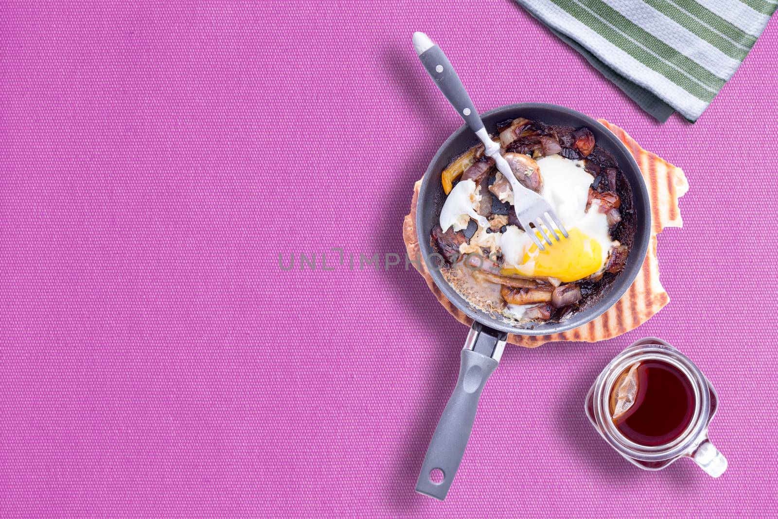 Sunny Side up Omelette on Violet Color Table Cloth with a Mason Cup Hot Tea, Copy Space Left at Left