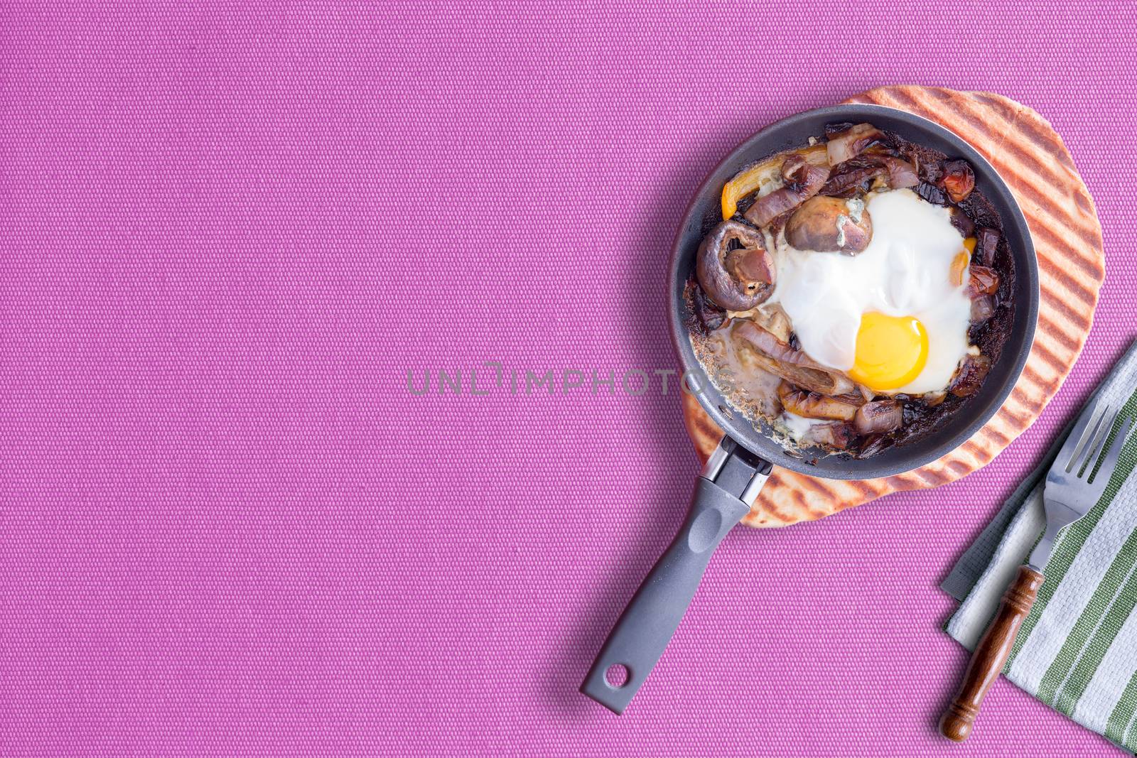 Sunny Side up Omelette on Violet Color Table Cloth, Copy Space at Left