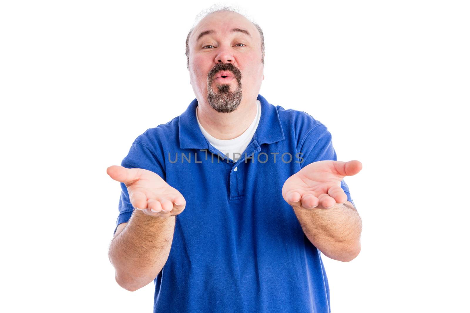 Persuasive middle-aged man with a goatee cajoling and pleading with his hands outstretched , upper body in a blue t-shirt isolated on white