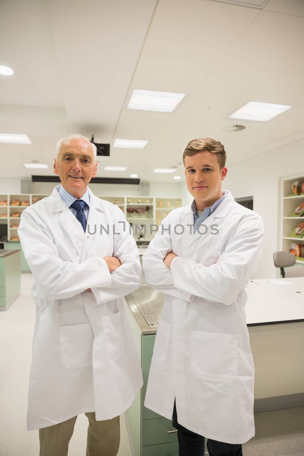 Science student and lecturer smiling at camera by Wavebreakmedia