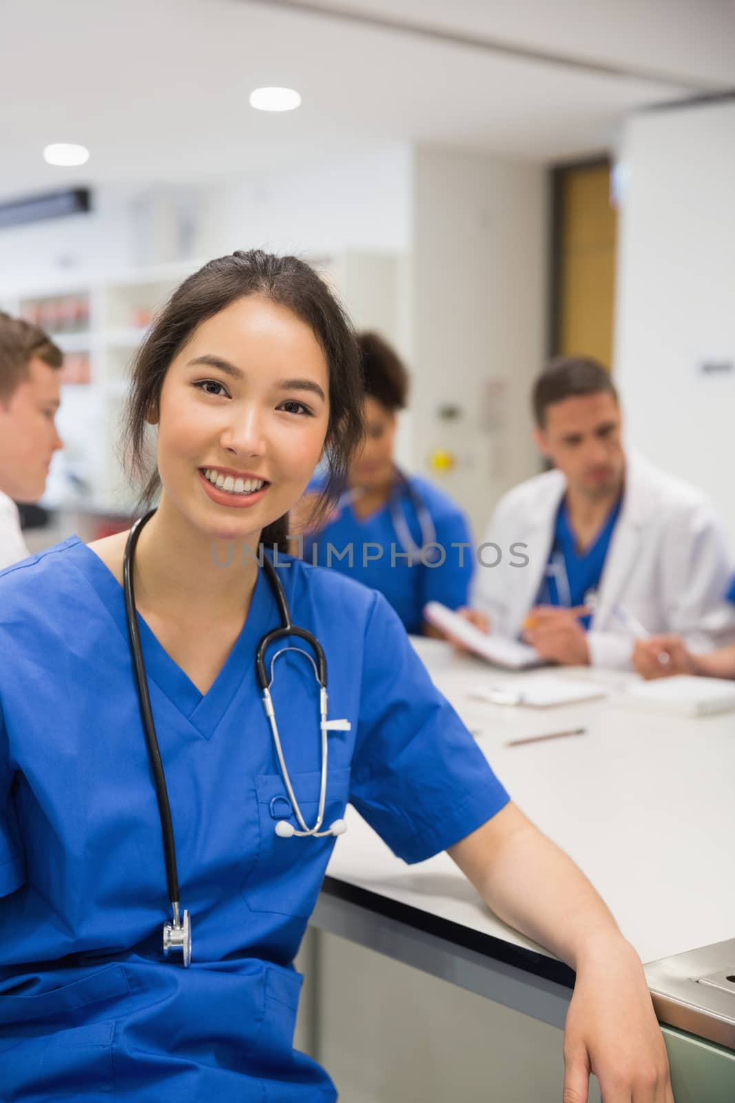 Medical student smiling at the camera during class at the university