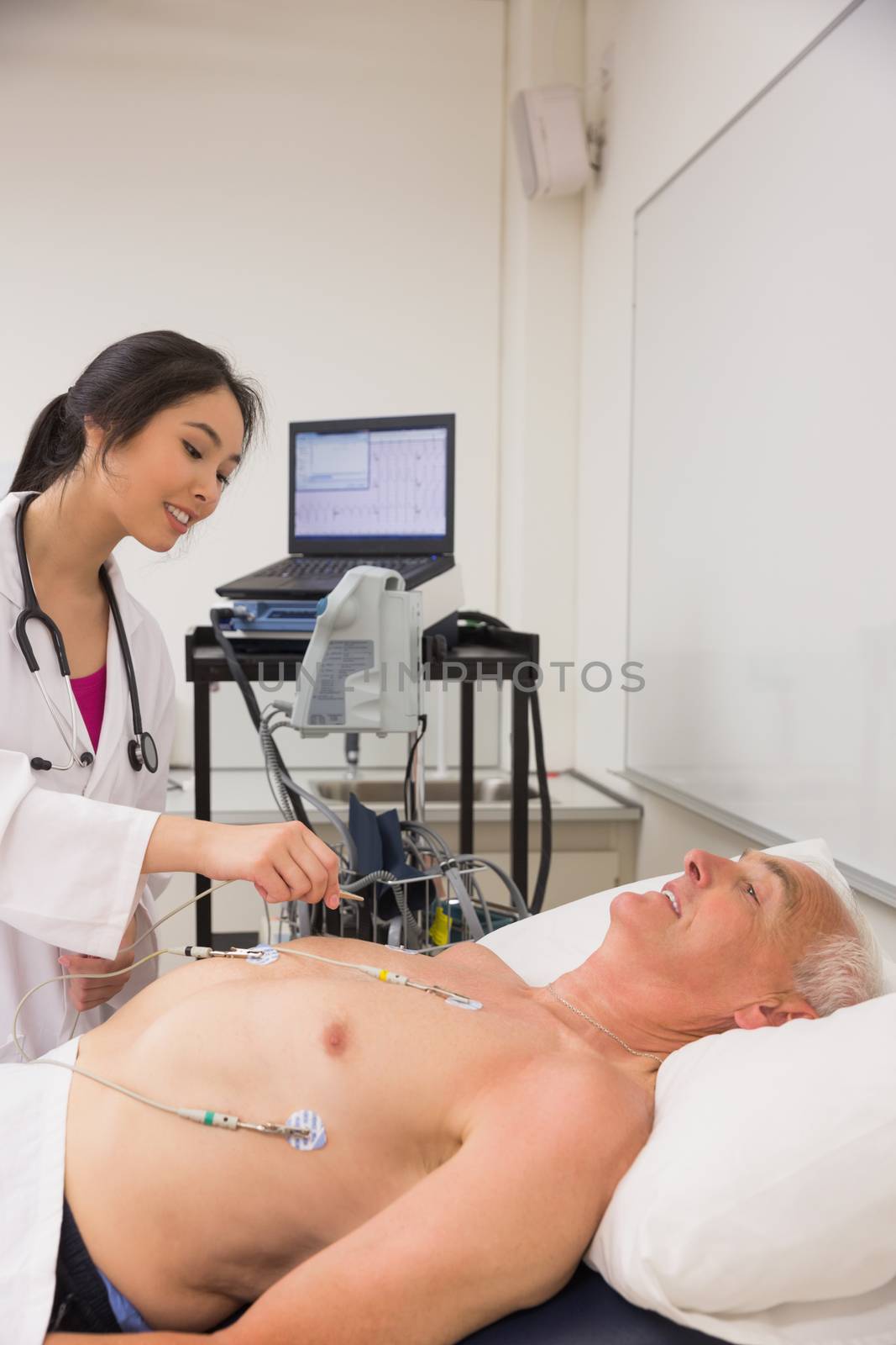 Medical student practicing on older man at the university