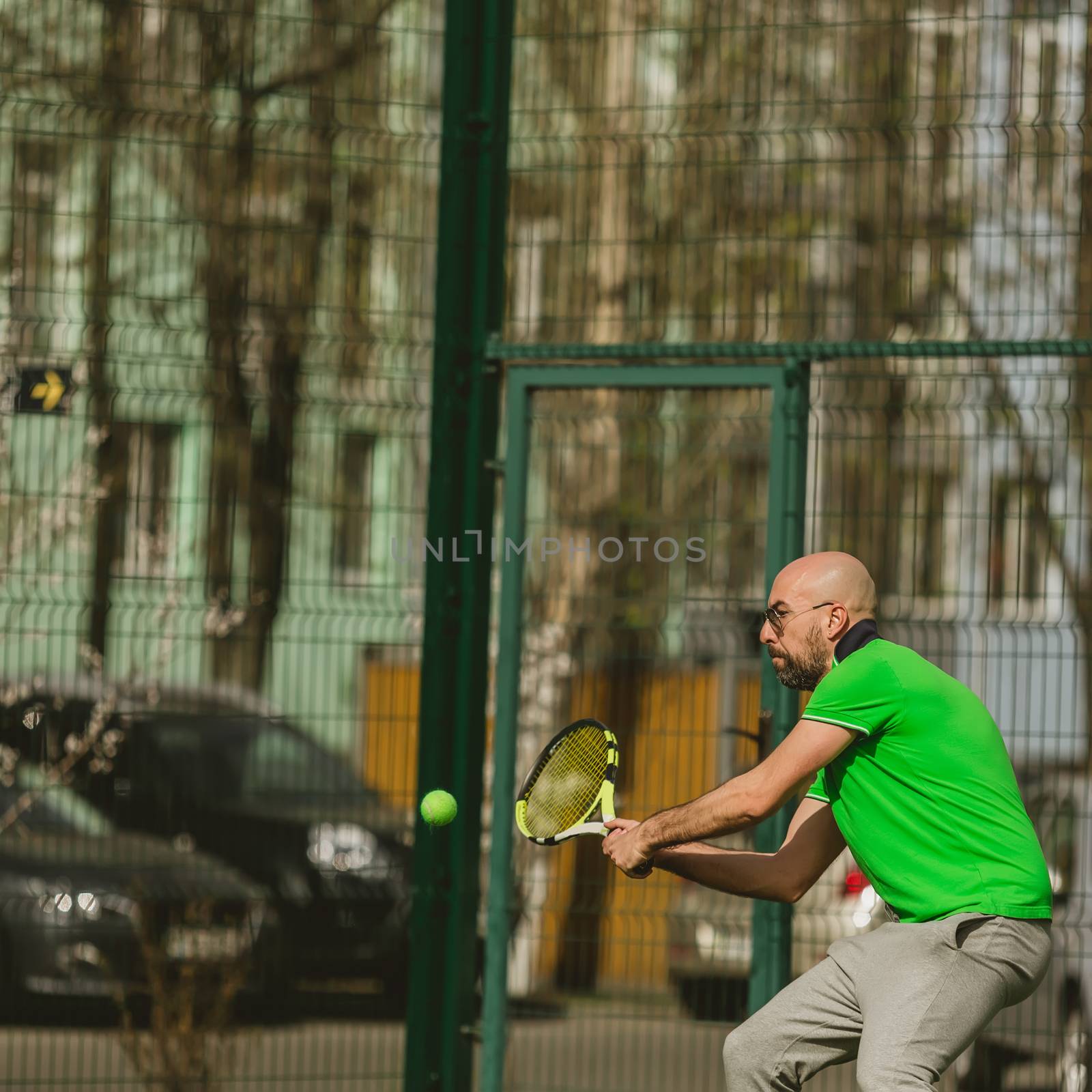 man play tennis outdoor by sarymsakov