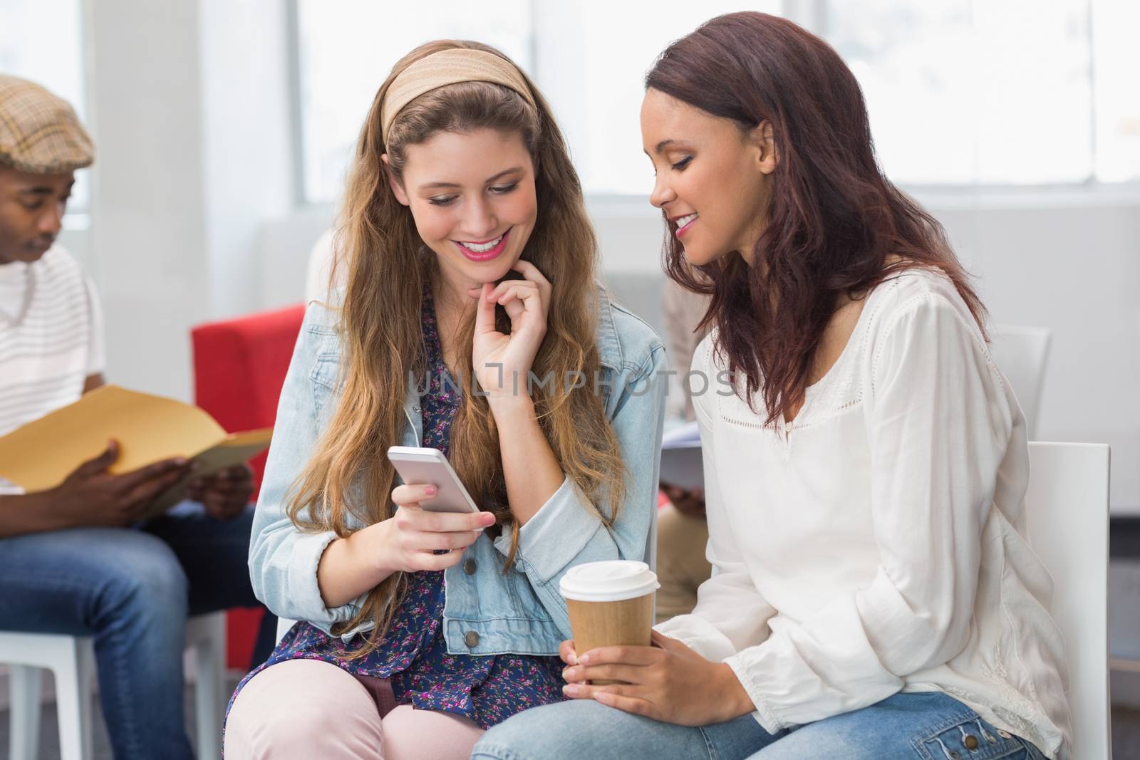 Fashion students chatting and smiling at the college