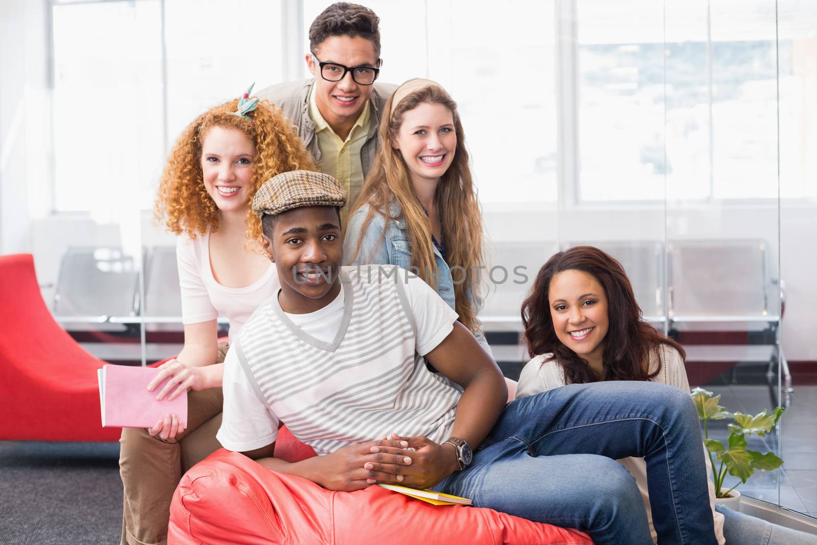 Fashion students smiling at camera together at the college