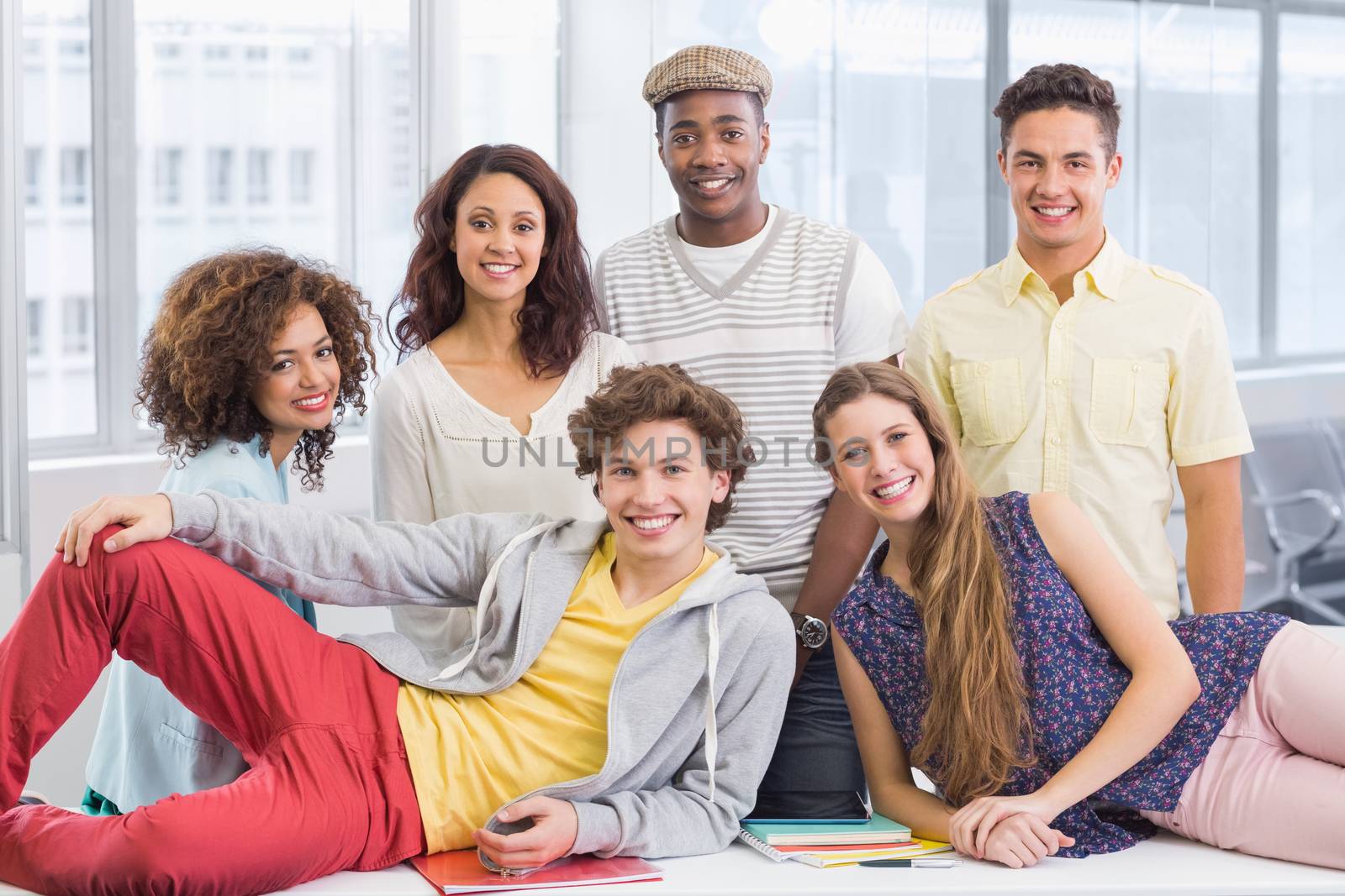 Fashion students smiling at camera at the college