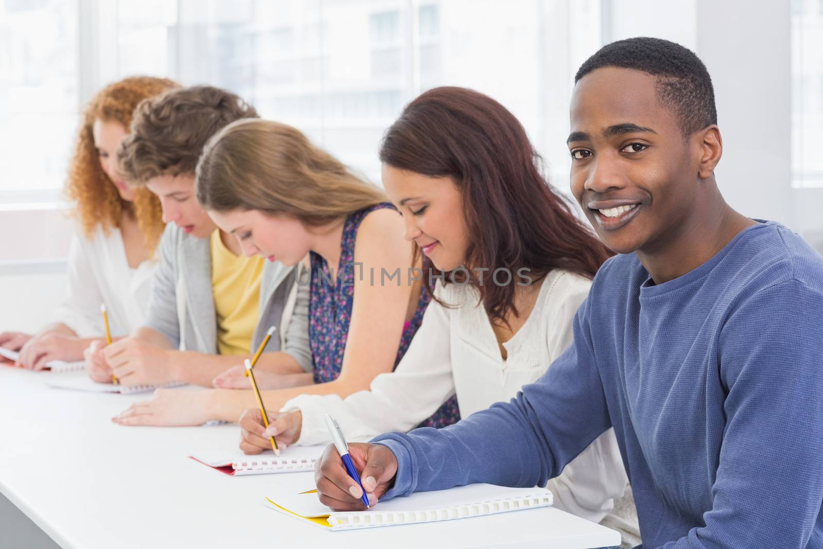 Fashion students being attentive in class by Wavebreakmedia