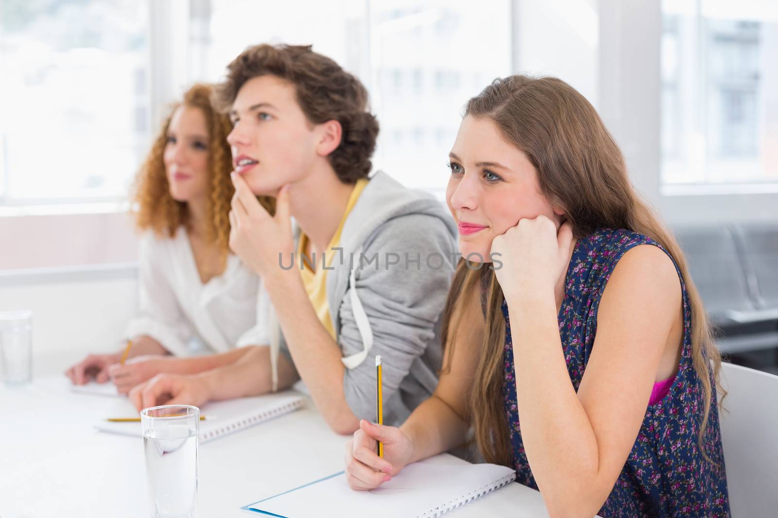 Fashion students being attentive in class by Wavebreakmedia