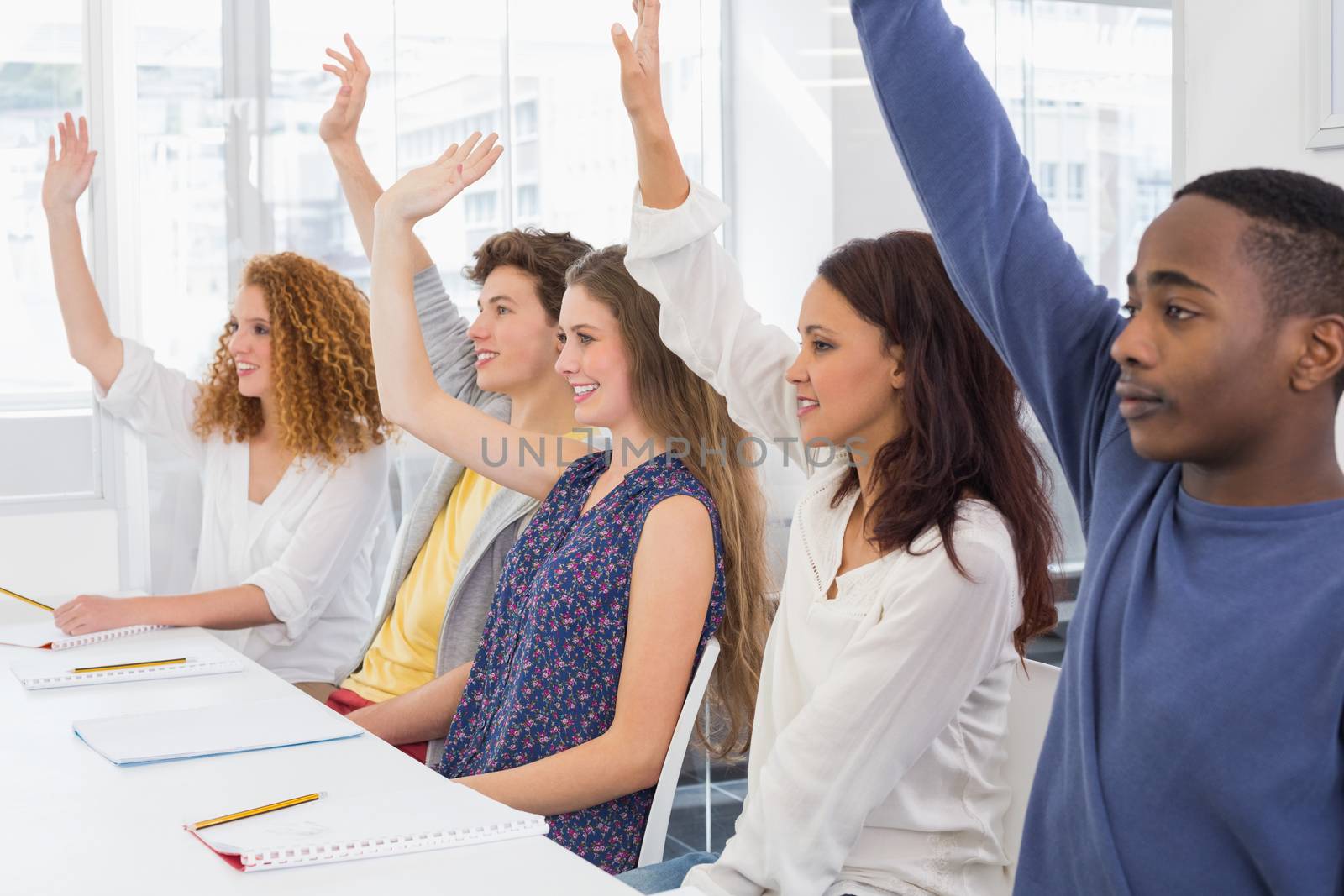 Fashion students being attentive in class by Wavebreakmedia