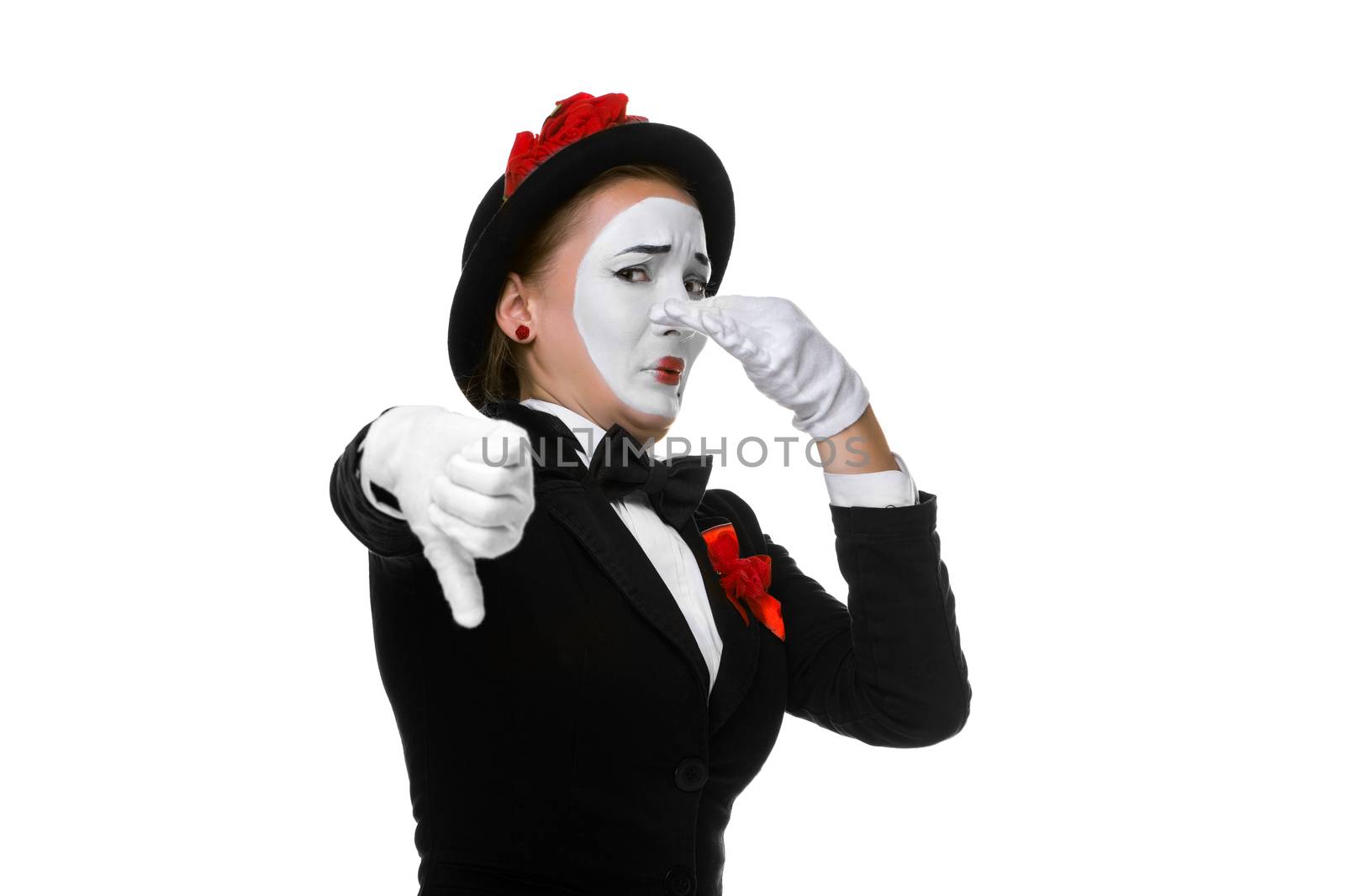 Portrait of the condemning woman as mime with dissatisfaction with a grimace on his face isolated on white background. Concept of  of rejection and condemnation