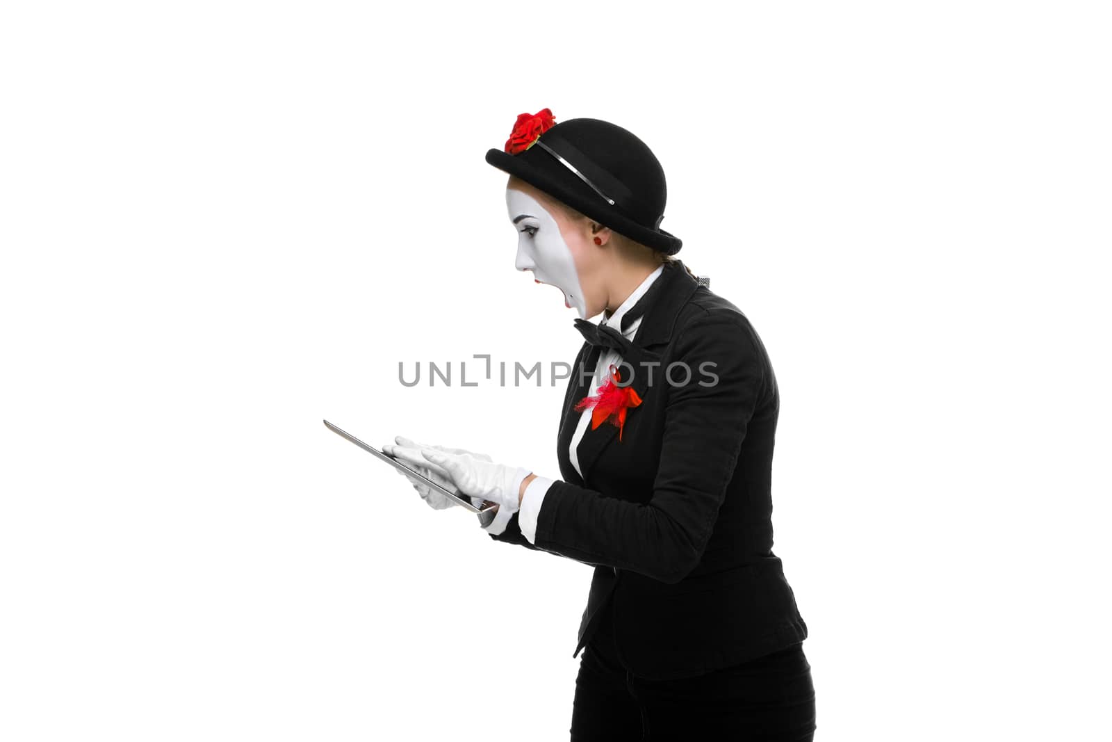 surprised business woman in the image mime holding tablet PC isolated on white background