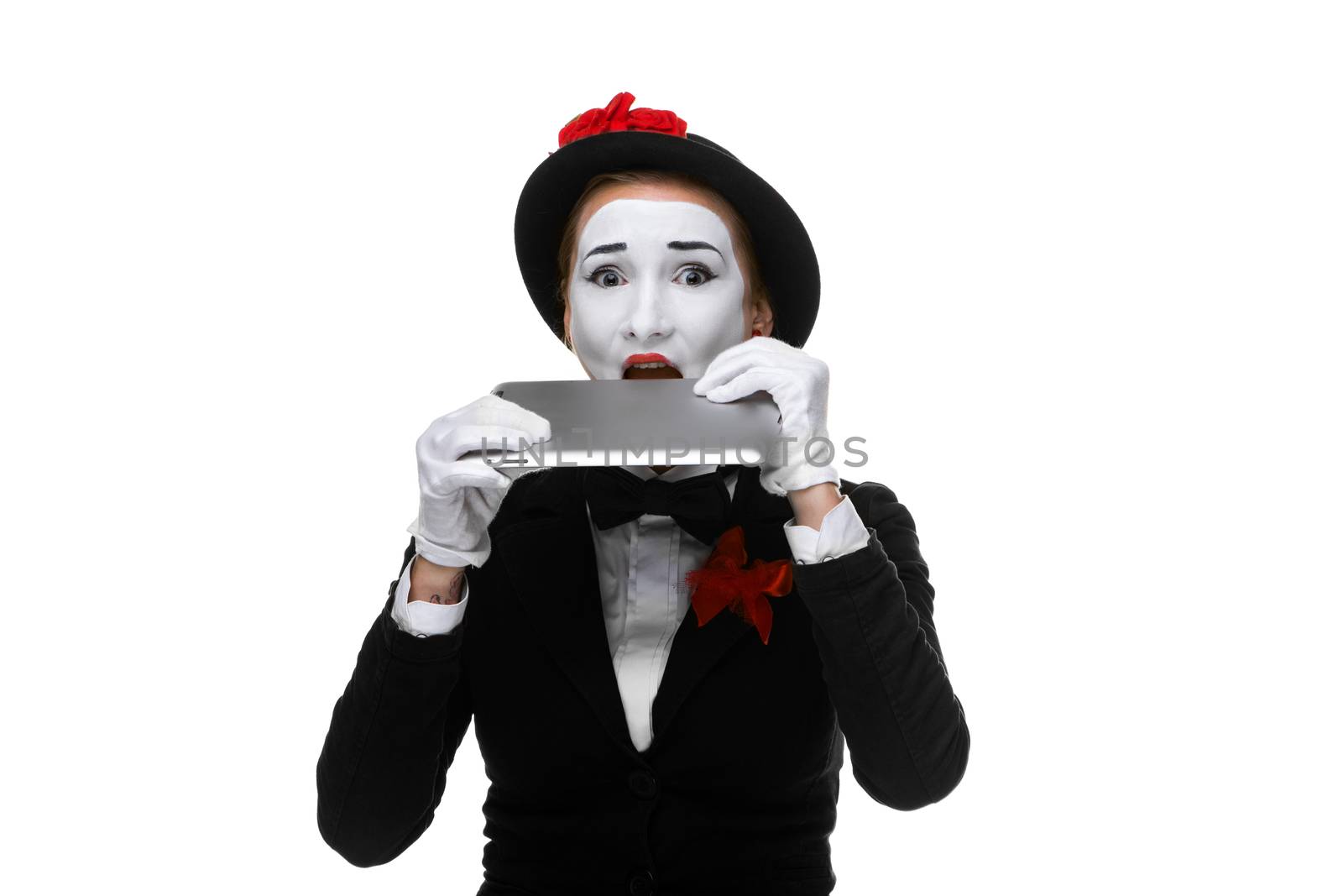 surprised business woman in the image mime holding tablet PC isolated on white background