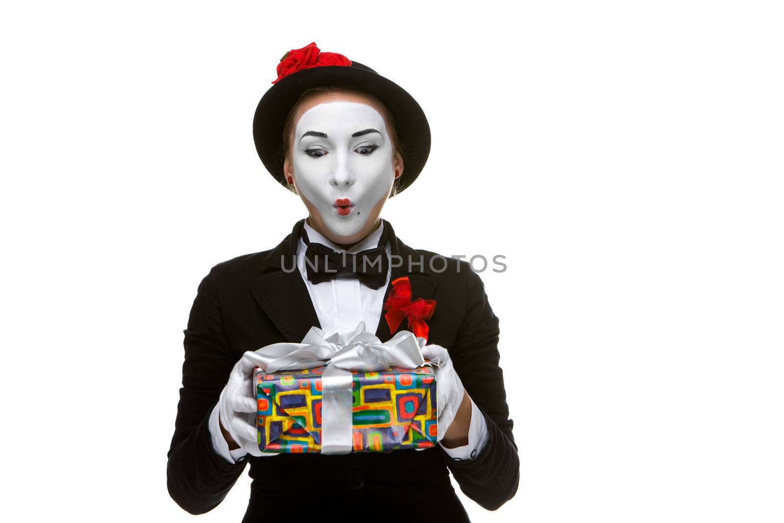 Mime as playful, joyful and excited woman with gift standing isolated on white background. 