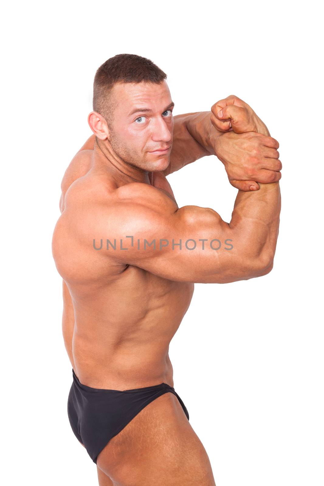 Bodybuilder posing. Huge muscular bodybuilder showing biceps isolated on white background. Sports and fitness.