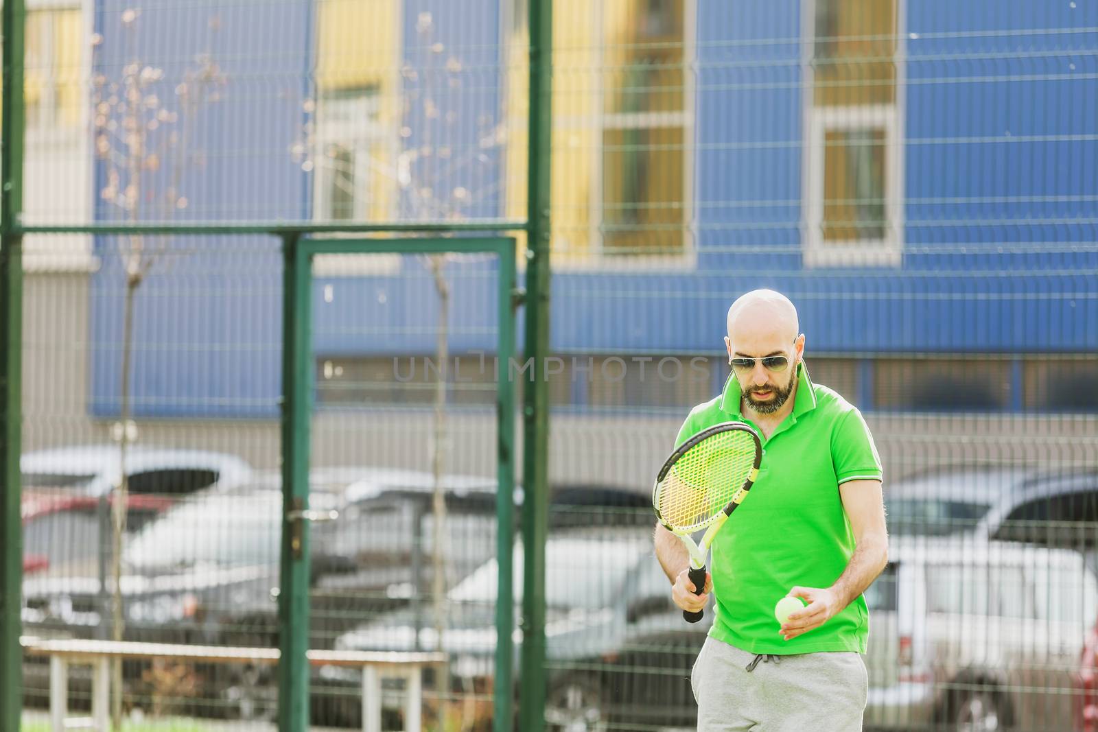 man play tennis outdoor by sarymsakov