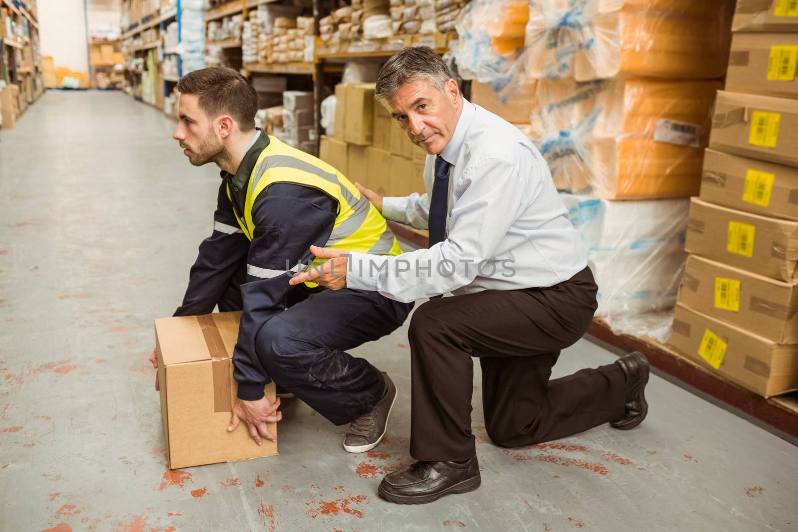 Manager training worker for health and safety measure in a large warehouse