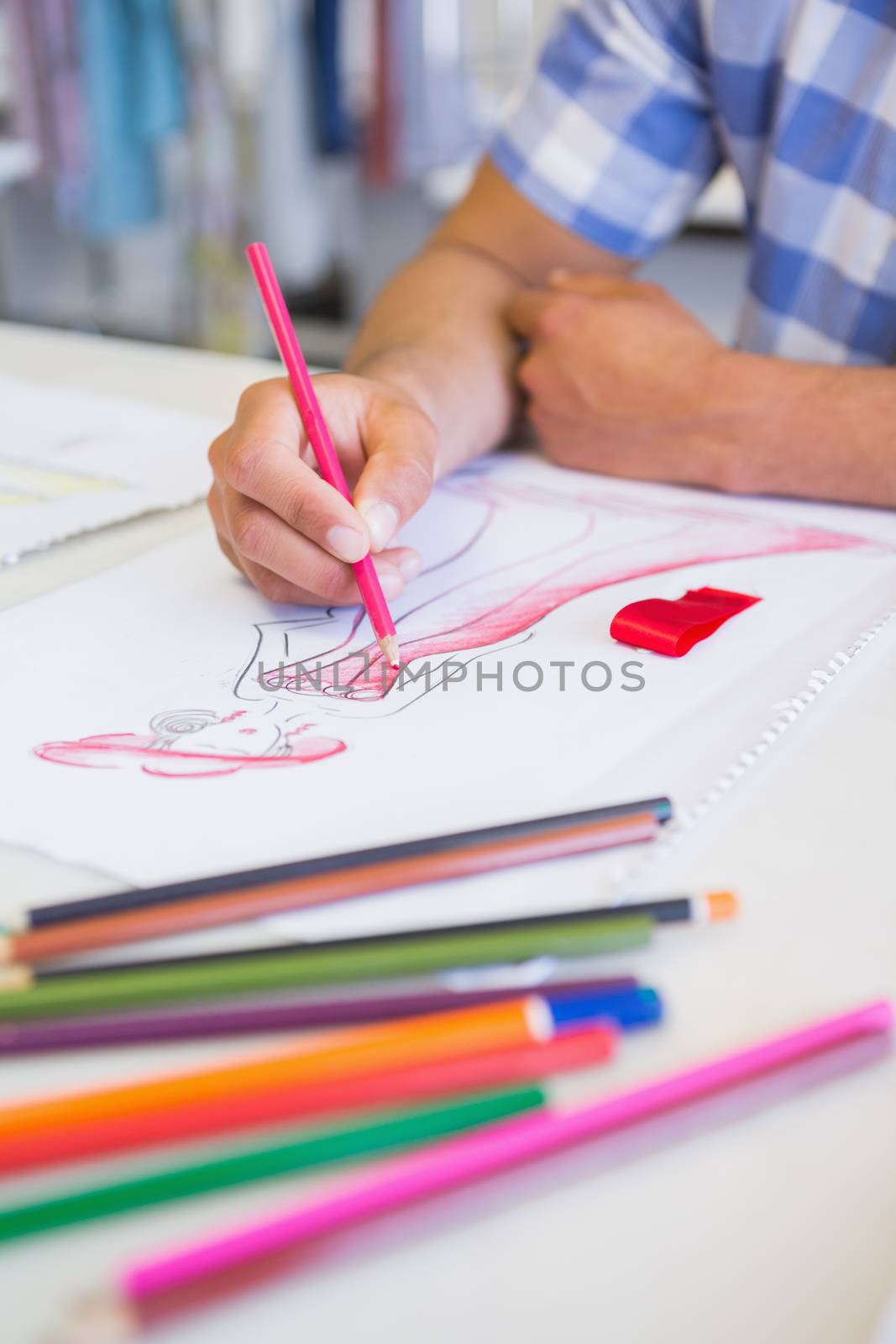 College student drawing picture with colored pencil by Wavebreakmedia