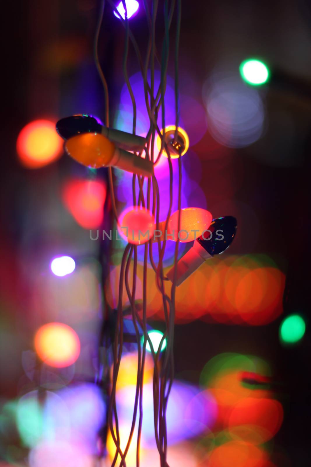 A string of colorful bulbs with a backdrop of colorful lights.A string of colorful bulbs with a backdrop of colorful lights.