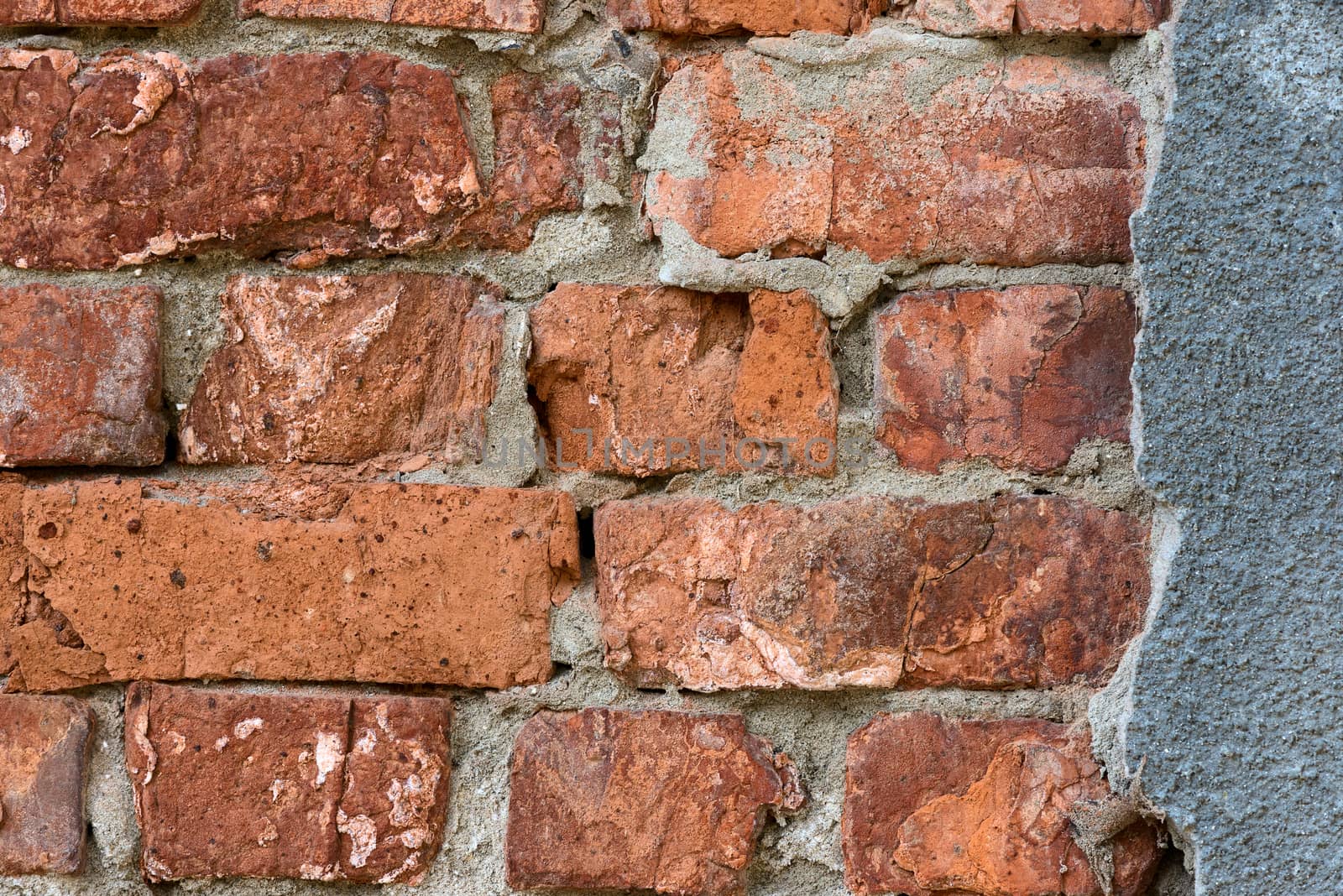 fragment of brick wall with light brown bricks and grey cement