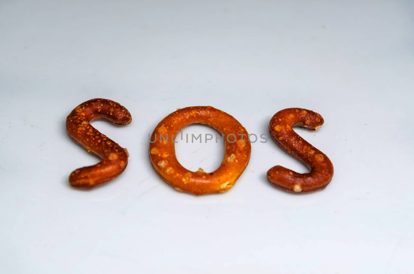 Savory biscuits as letters and the word SOS written.