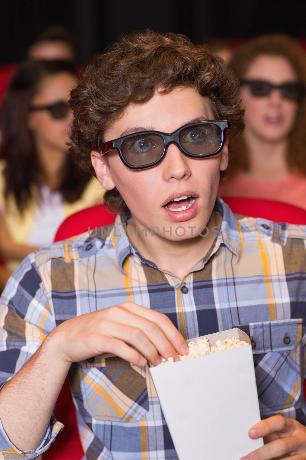 Young friends watching a 3d film at the cinema