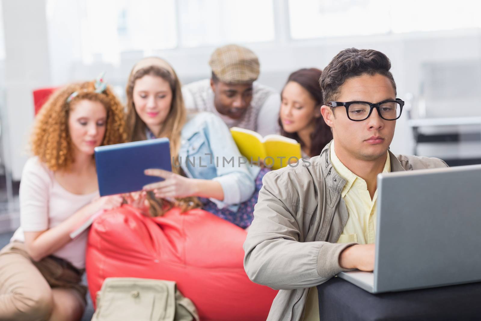 Fashion student using his laptop by Wavebreakmedia