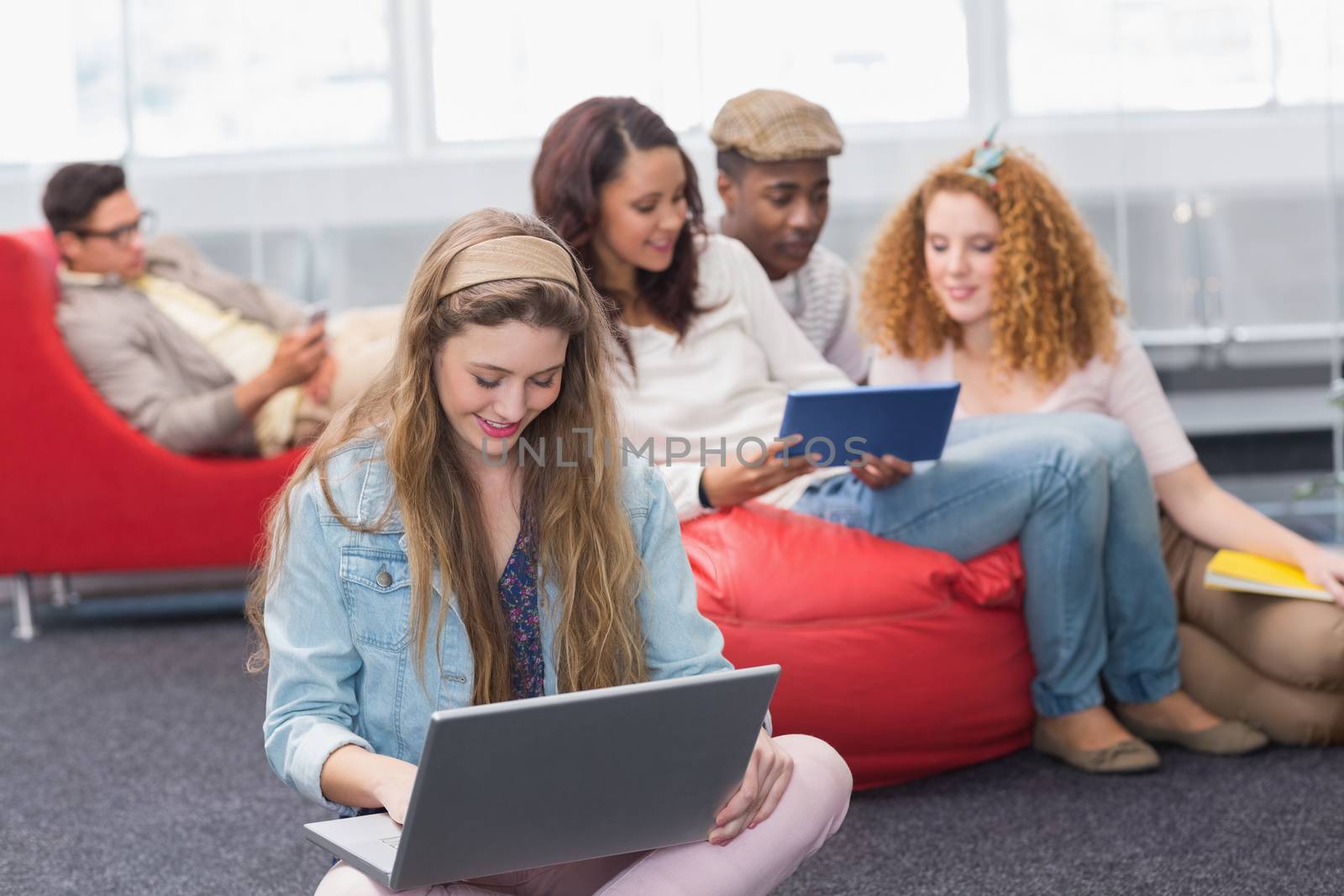 Fashion student using her laptop at the college