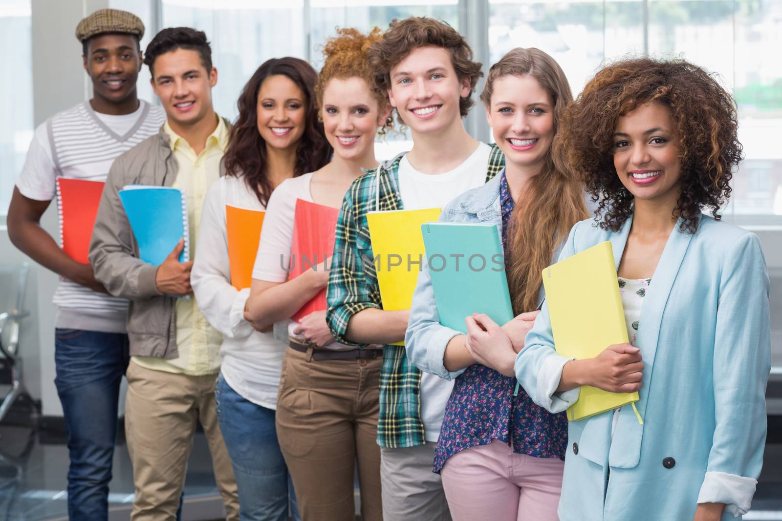 Fashion students smiling at camera together by Wavebreakmedia