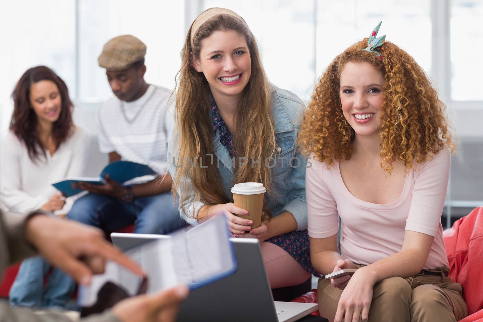 Fashion students smiling at camera together at the college