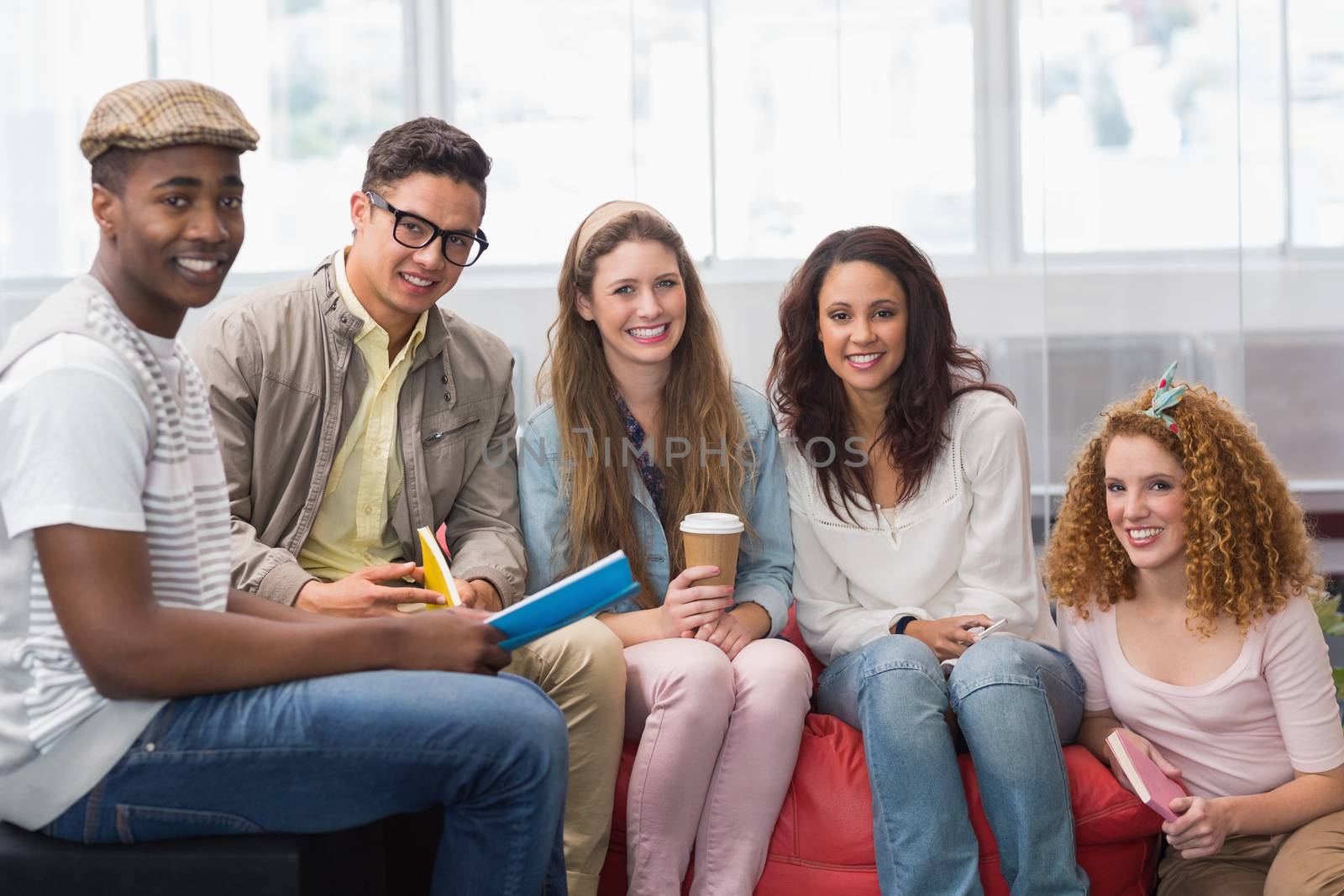 Fashion students smiling at camera together at the college