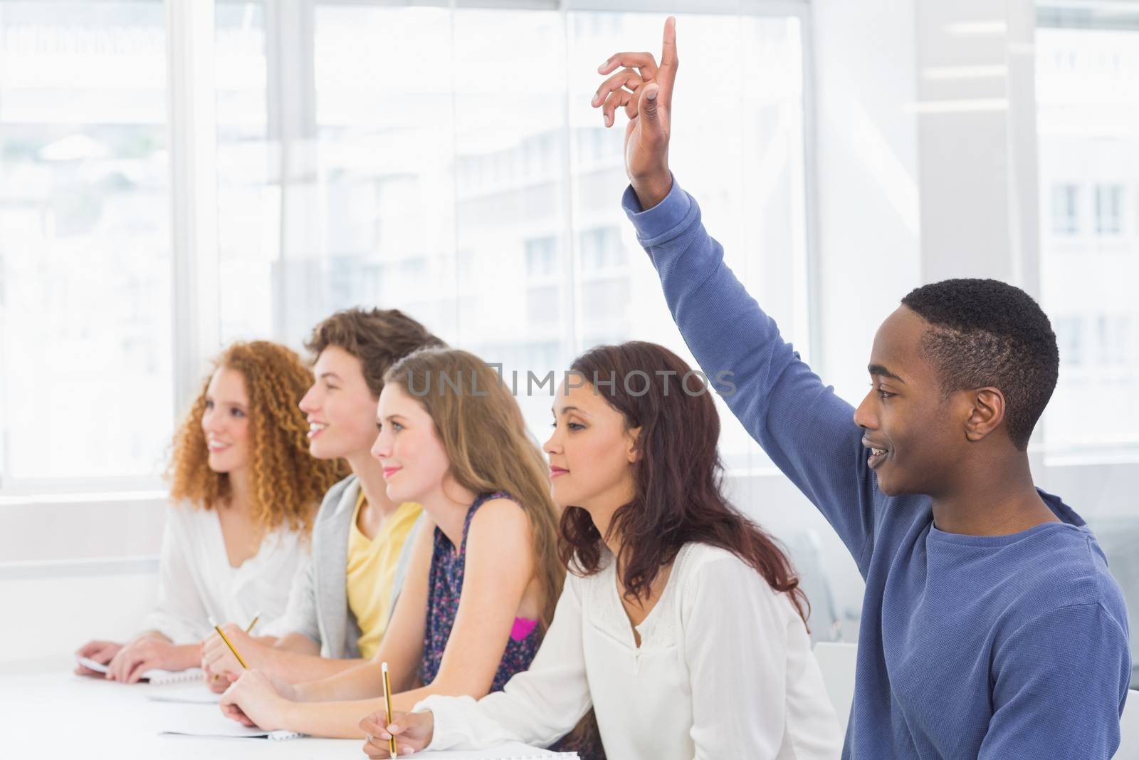 Fashion students being attentive in class by Wavebreakmedia