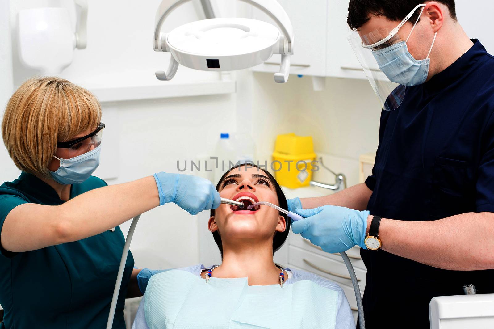 Female patient receiving treatment from dentist