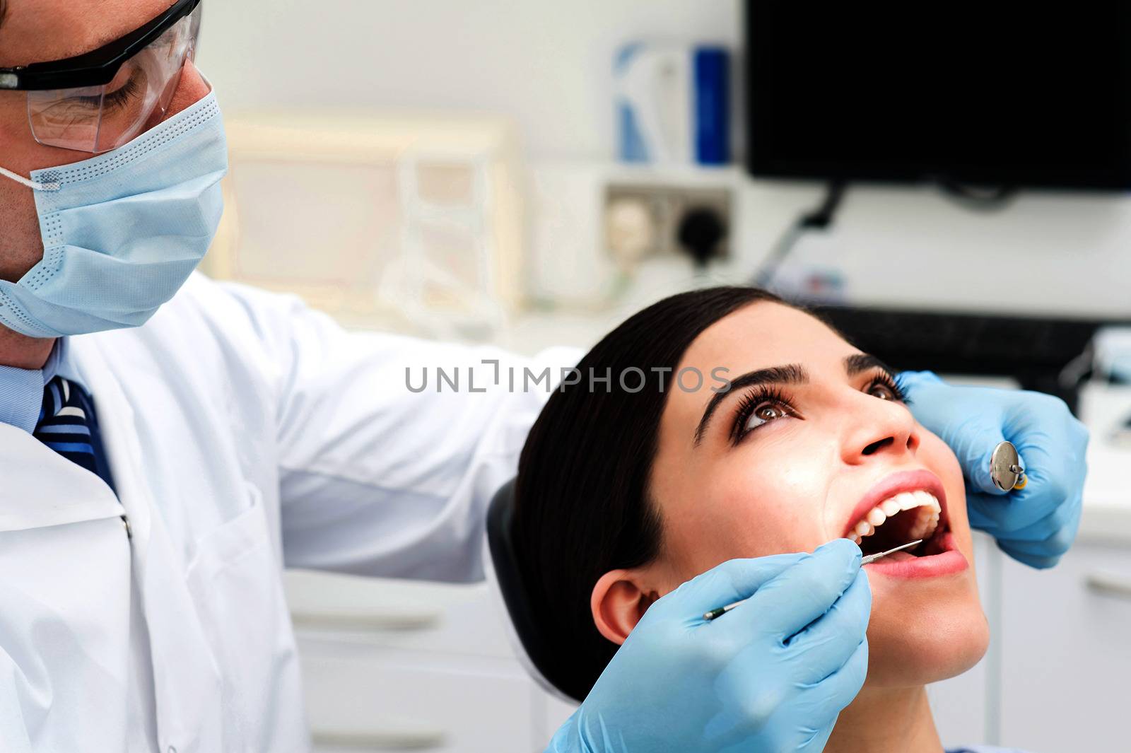Female patient open her mouth during treatment
