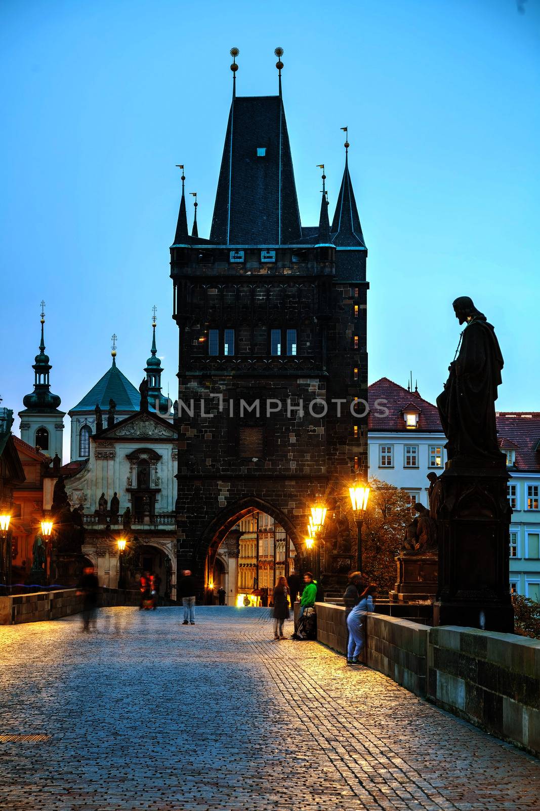 PRAGUE - OCTOBER 17: Charles bridge in the morning on October 17, 2014 in Prague. This famous historic bridge crosses the Vltava river and was constructed in the beginning of the 15th century.