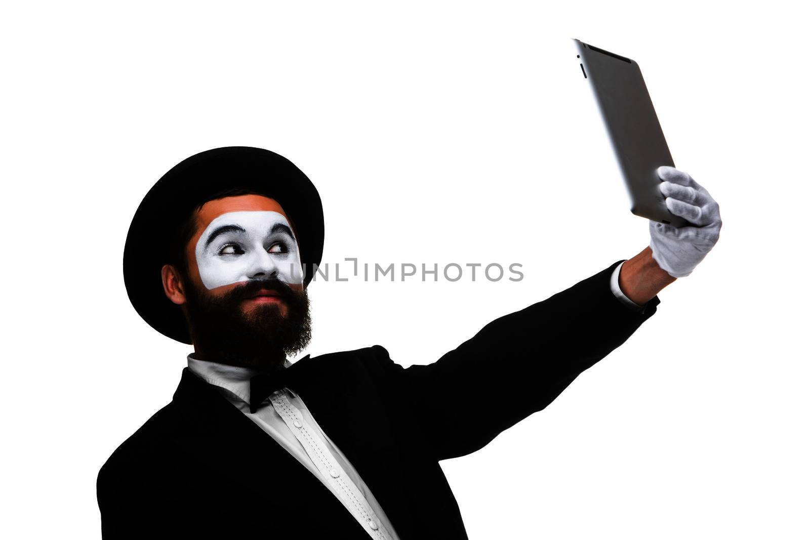 Man with a face mime working on a laptop isolated on a white background. concept of fatigue in business